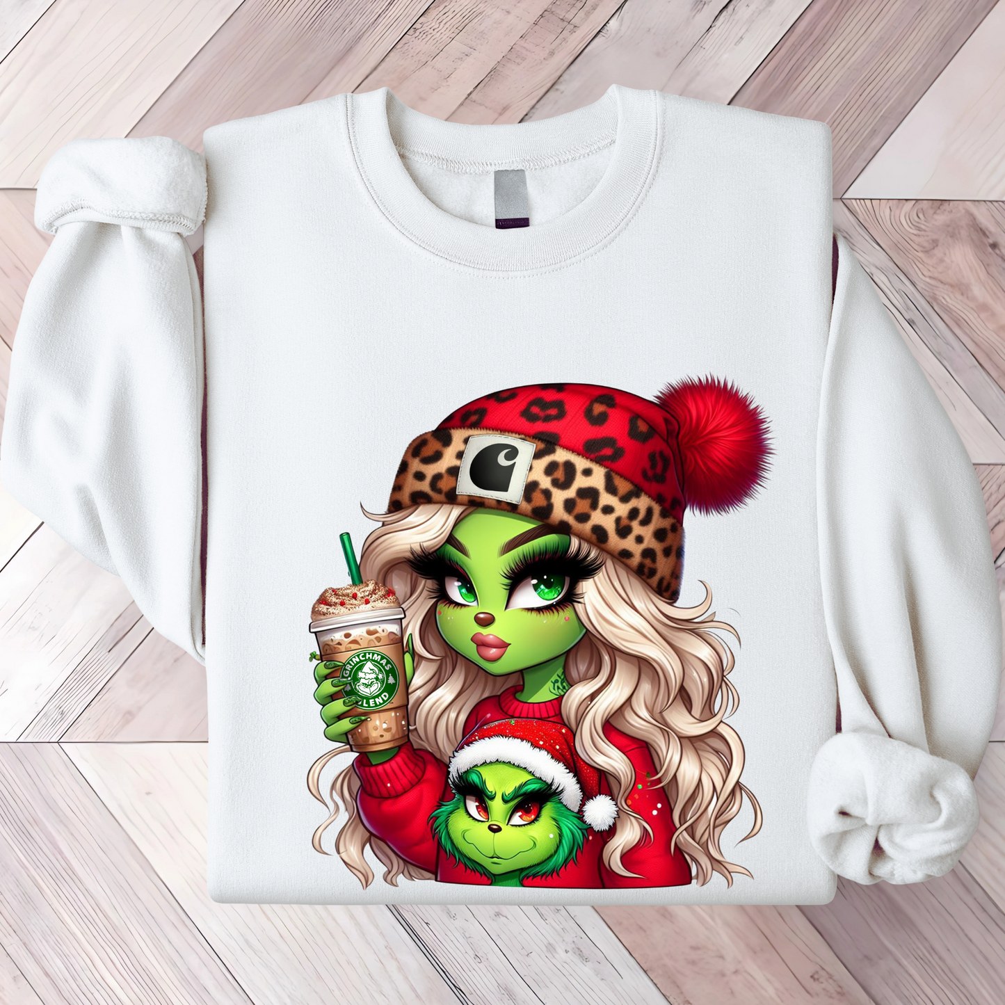 Smiling woman in a white Green Girl sweatshirt holding a drink, styled with cozy winter decor.