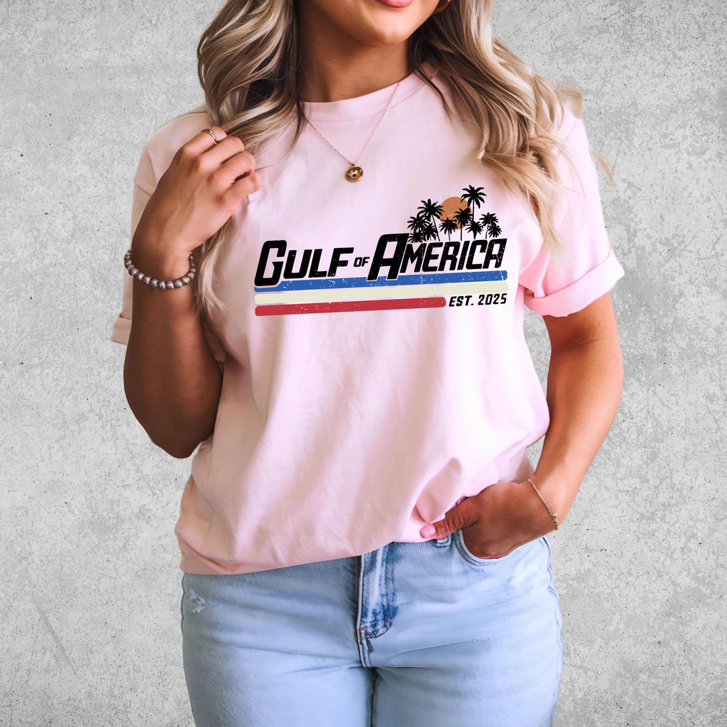 Woman in light pink patriotic Gulf of America graphic tee with red and blue stripes