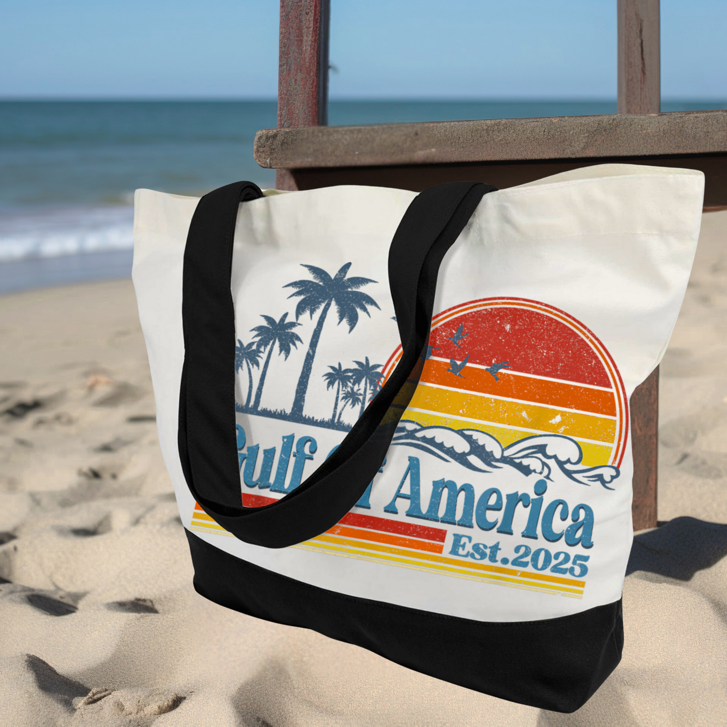 Gulf of America canvas tote bag in sand with ocean view, retro palm tree and sun graphic with black handles