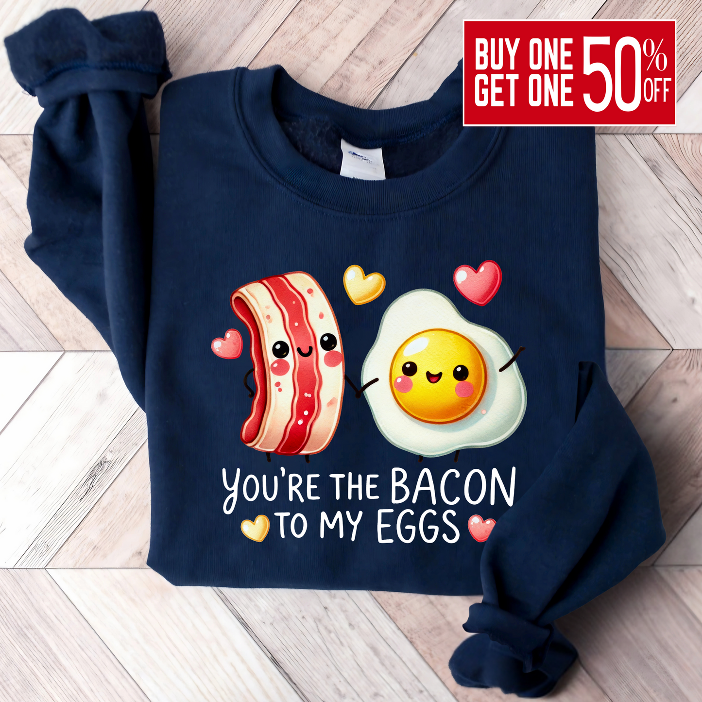 Navy folded sweatshirt with bacon and eggs graphic and romantic saying