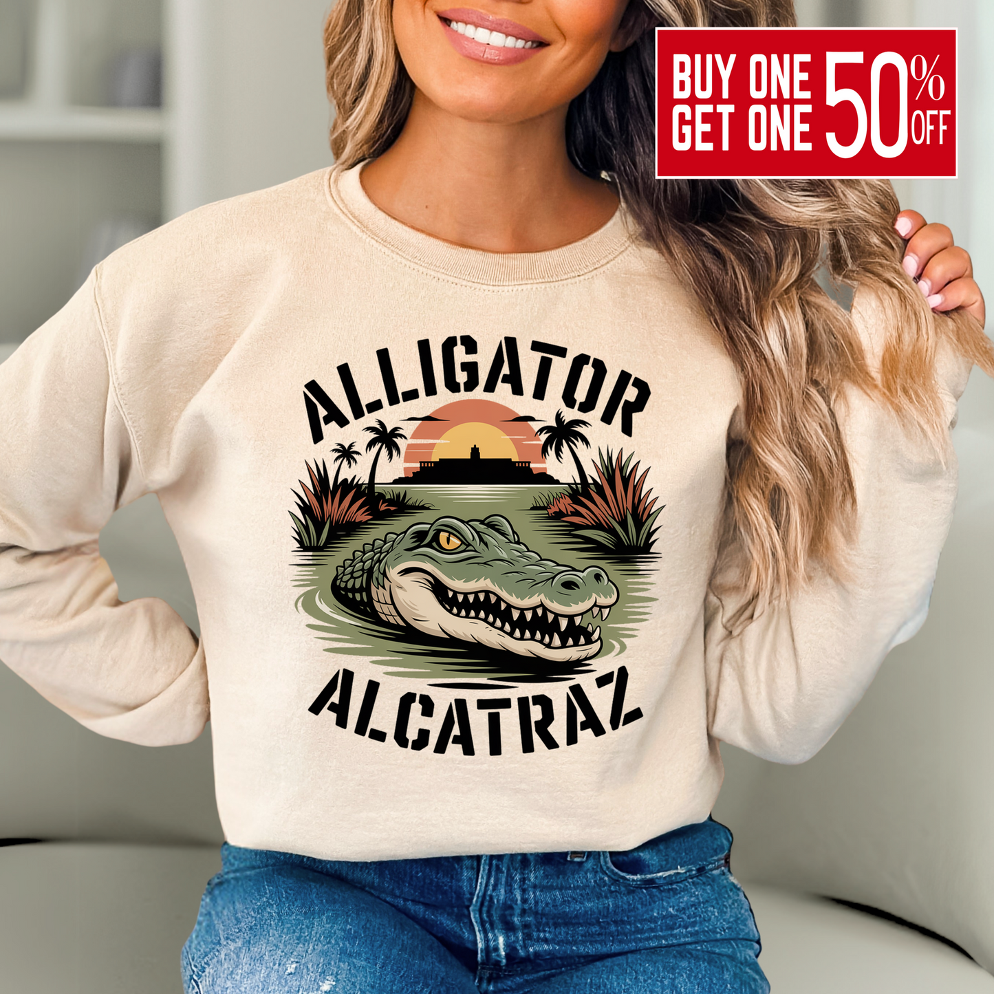 Woman wearing sand colored Alligator Alcatraz sweatshirt with bold alligator and sunset island graphic, cozy women’s casual pullover for travel or lounging