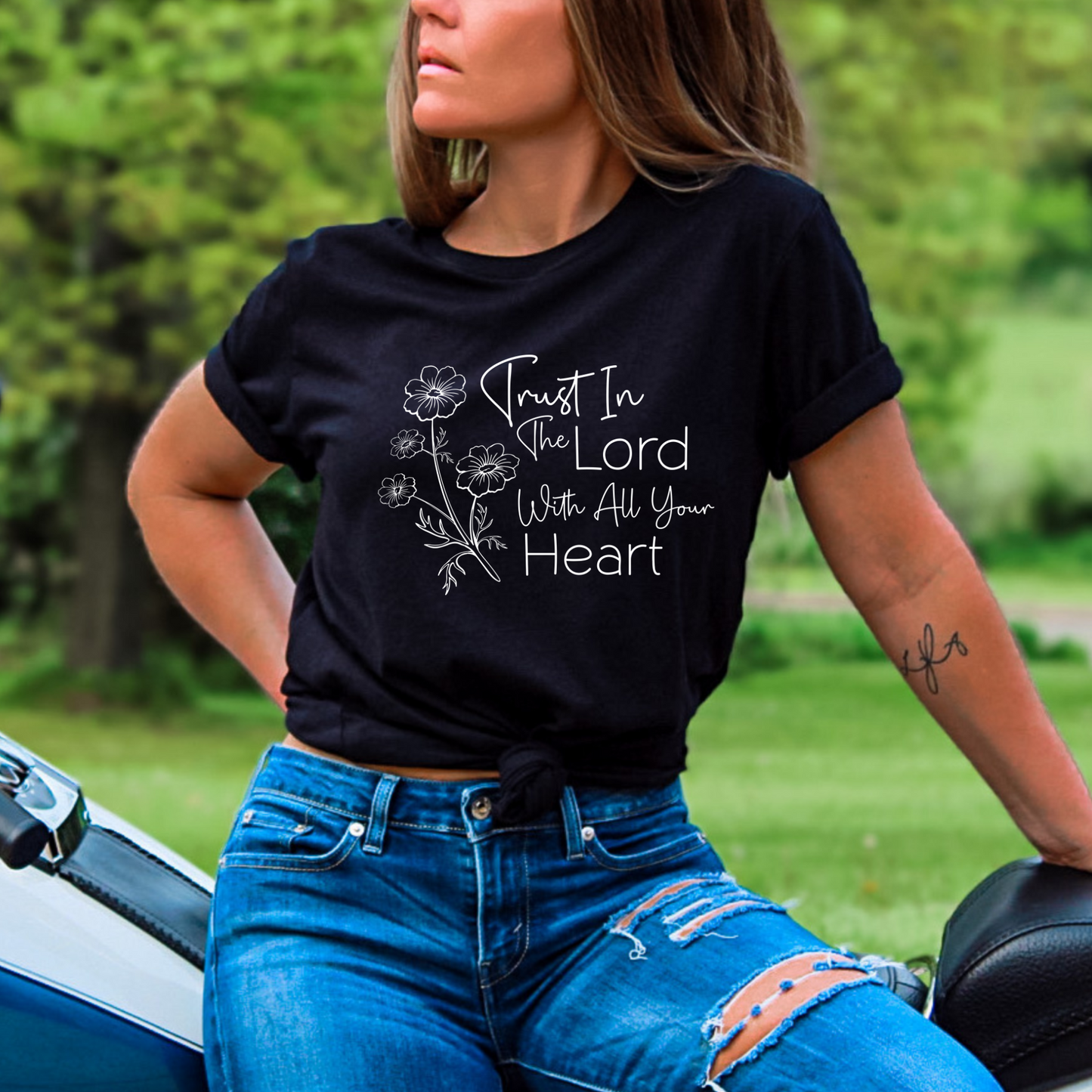 Christian graphic tee featuring ‘Trust in the Lord’ scripture with a delicate floral print. Comfortable, stylish, and faith-inspired apparel for women