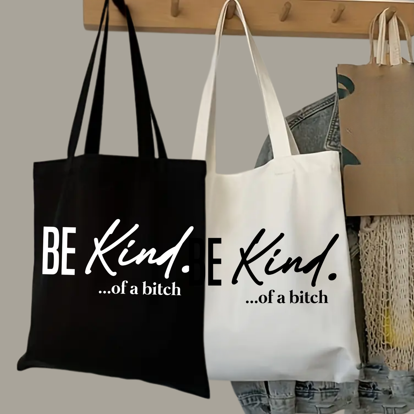 Black and white tote bags on hooks with “Be Kind ...of a Bitch” phrase