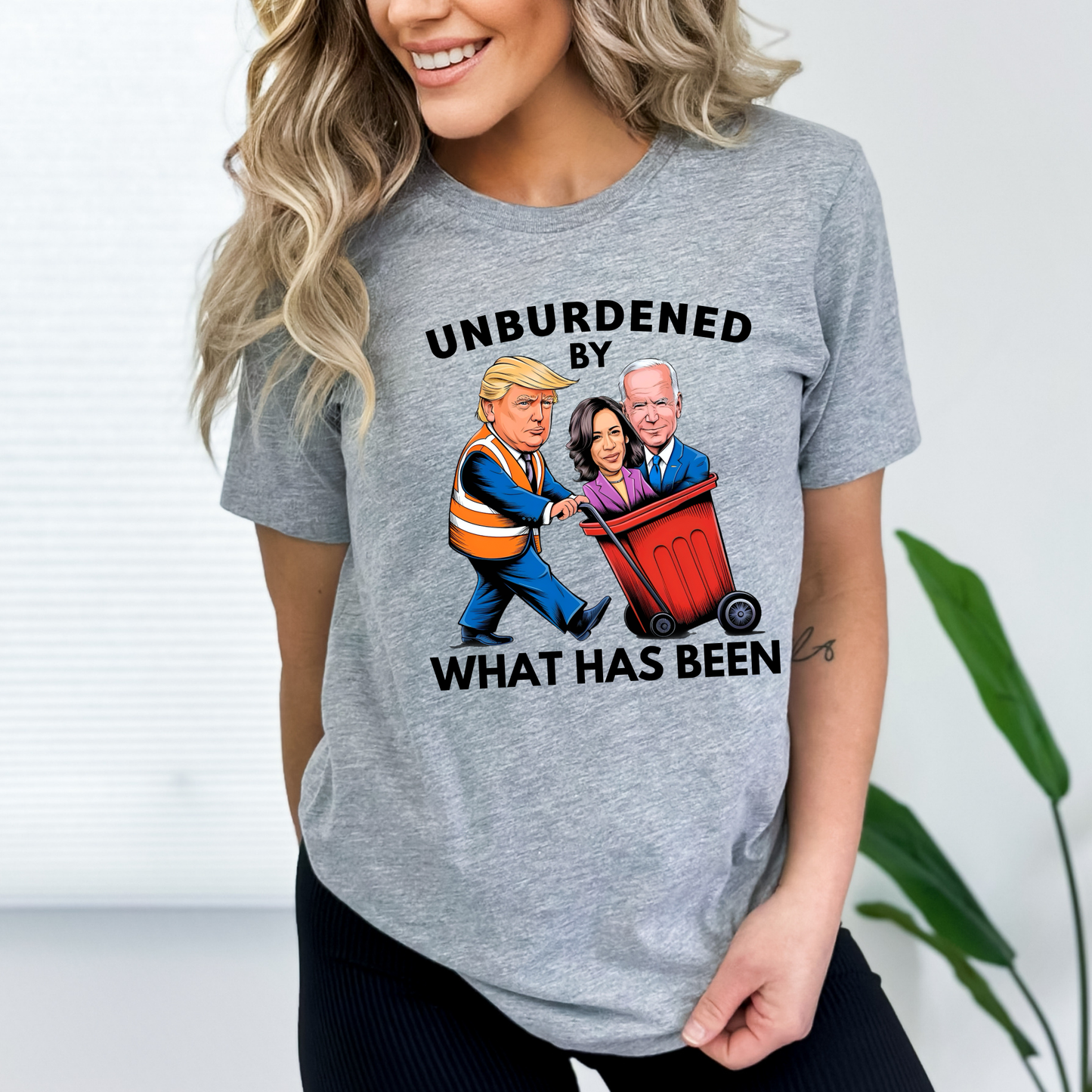 Gray relaxed fit shirt with cartoon Trump throwing away Biden and Kamala – women's political statement tee