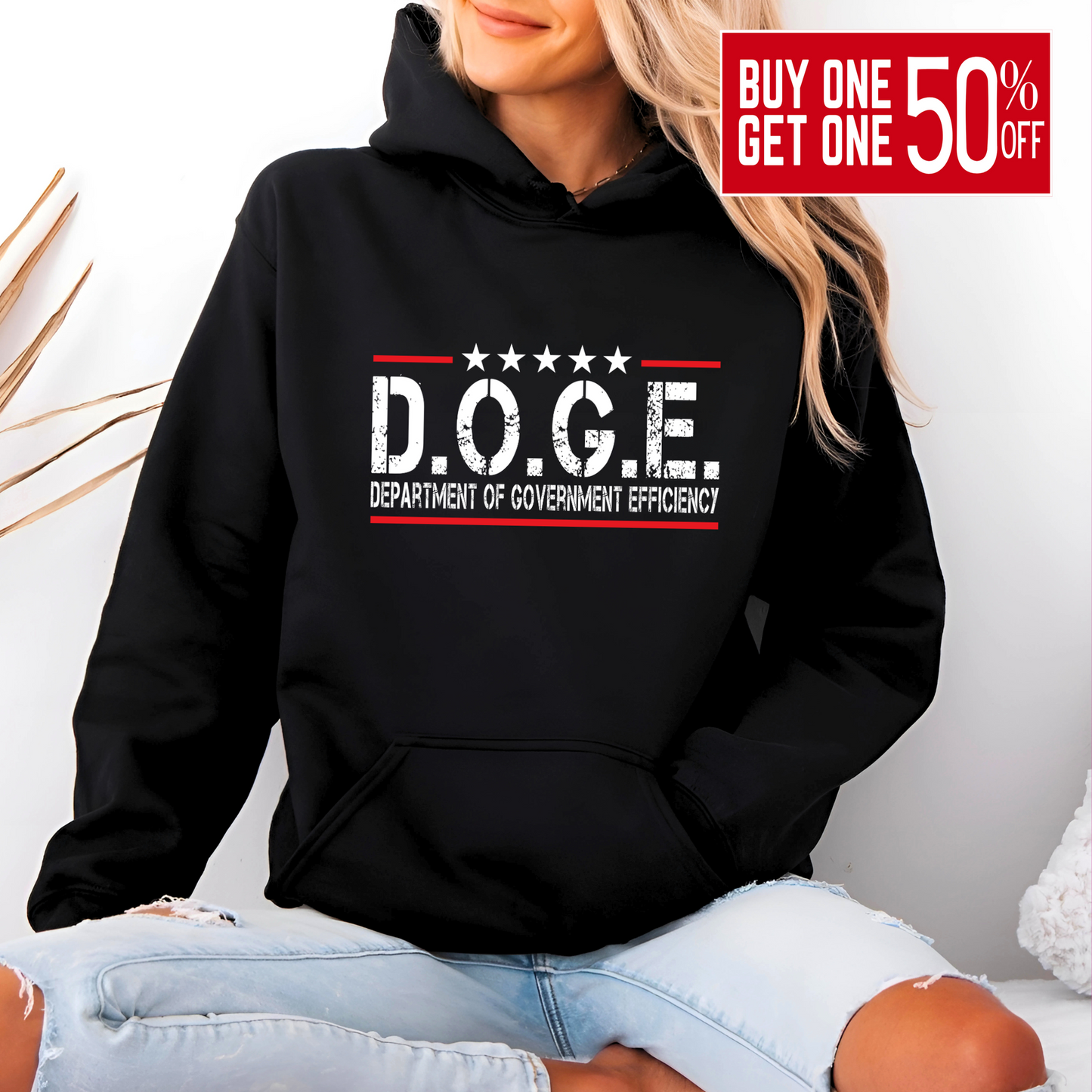 Woman wearing black hoodie with bold D.O.G.E. Department of Government Efficiency graphic in white and red, patriotic and sarcastic design