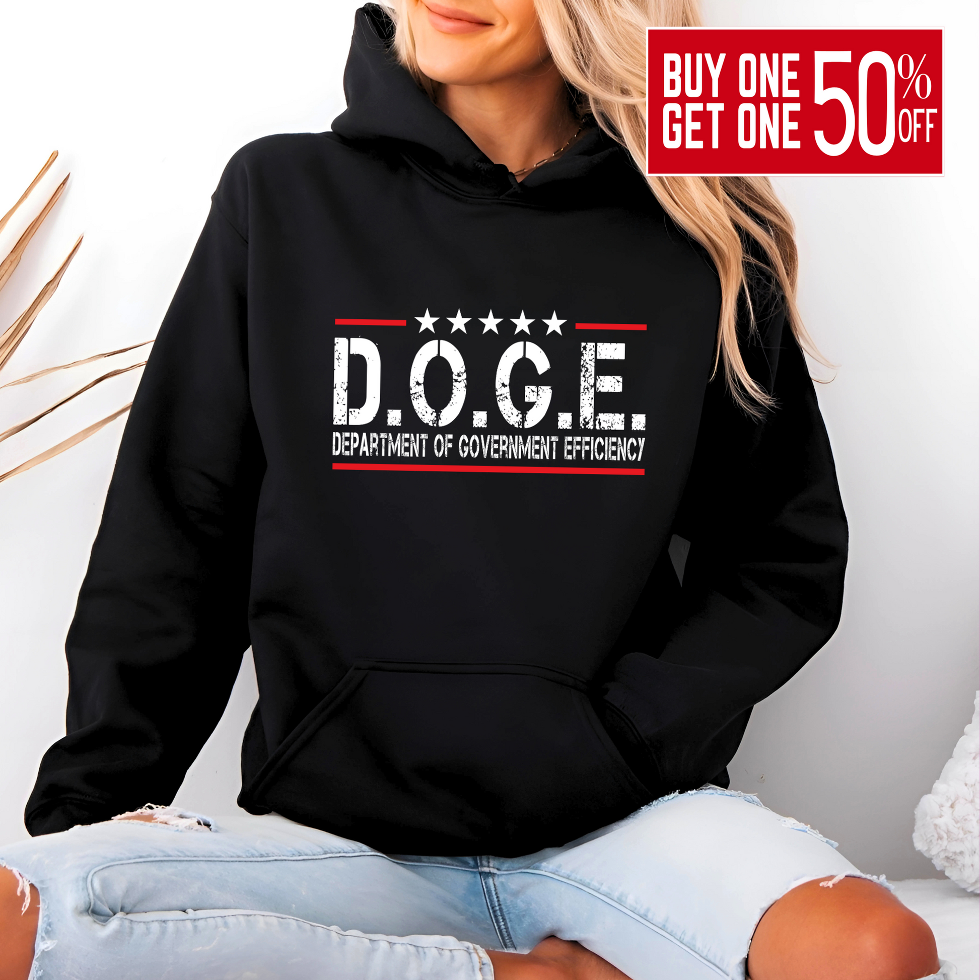 Woman wearing black hoodie with bold D.O.G.E. Department of Government Efficiency graphic in white and red, patriotic and sarcastic design