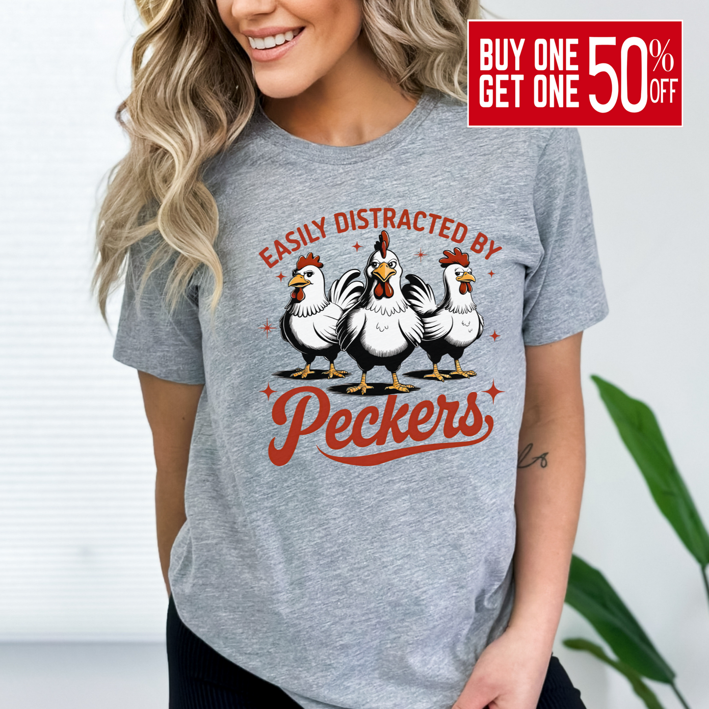 Woman wearing a Gray T-shirt with "Easily Distracted by Peckers" text and three funny chickens design. Perfect for chicken lovers and humor enthusiasts