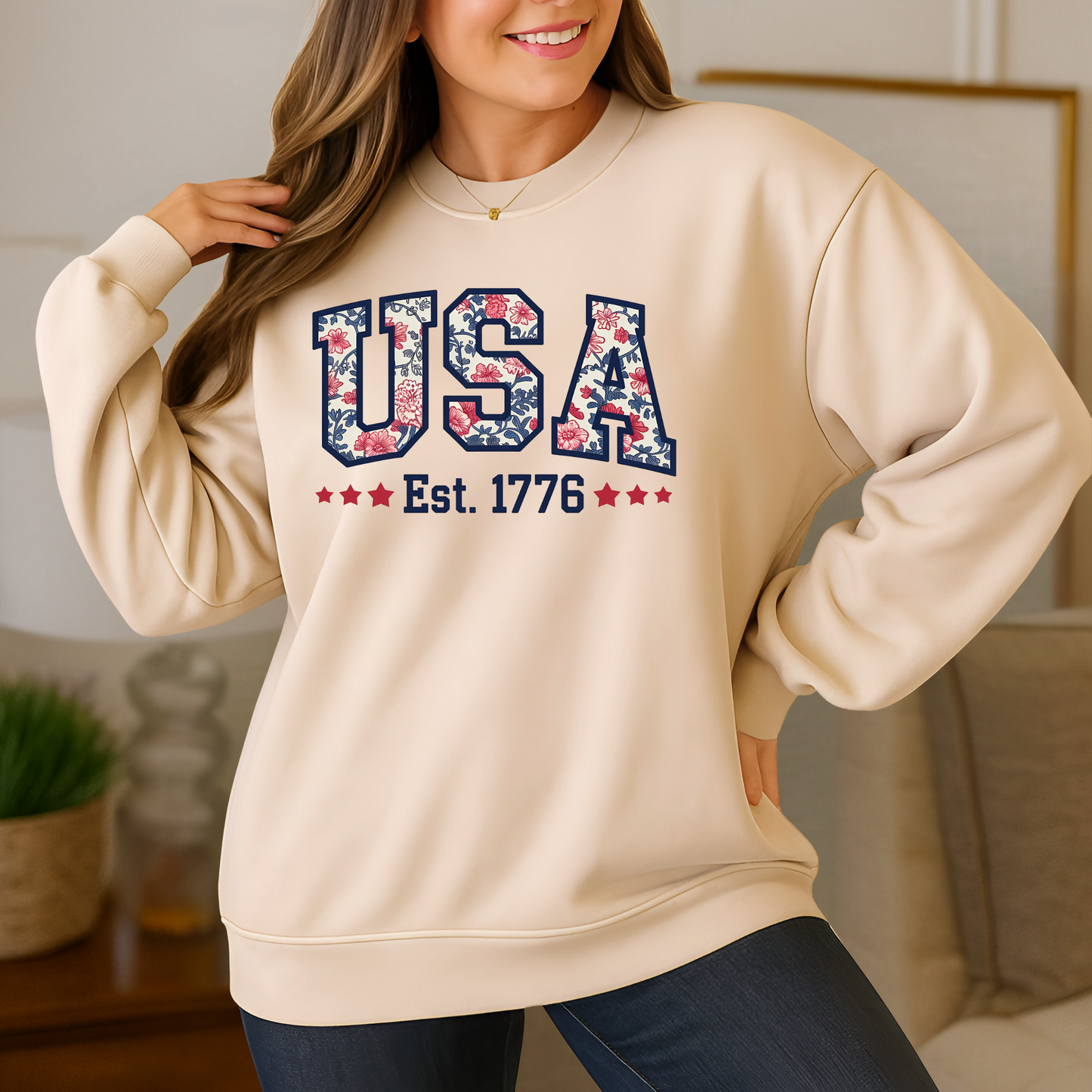 Woman wearing tan USA Est. 1776 floral crewneck sweatshirt – cozy patriotic loungewear.