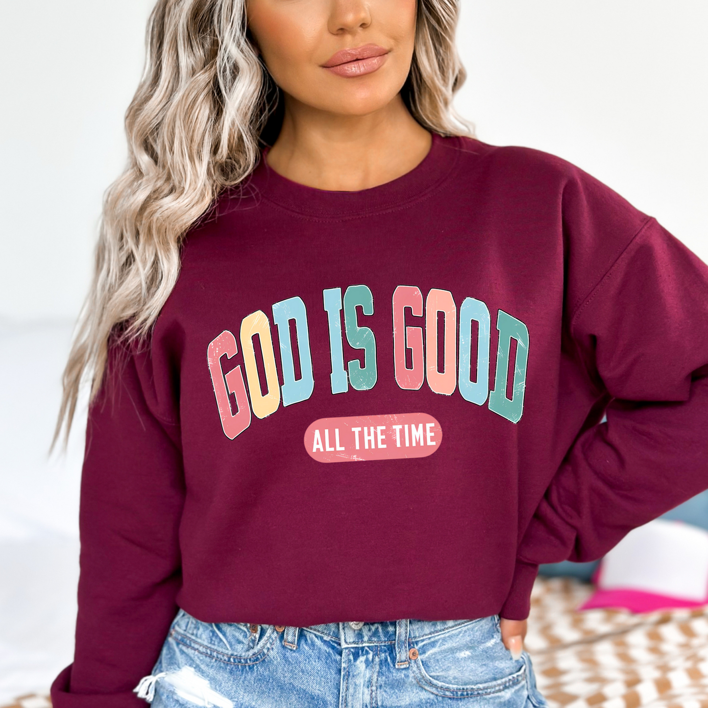 Woman wearing a maroon easter 'God Is Good' Christian sweatshirt, faith-based crewneck with inspirational design.