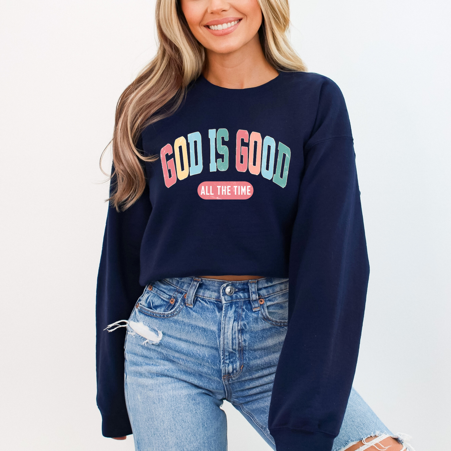 Woman wearing a Navy 'God Is Good' Christian sweatshirt, faith-based crewneck with inspirational design.