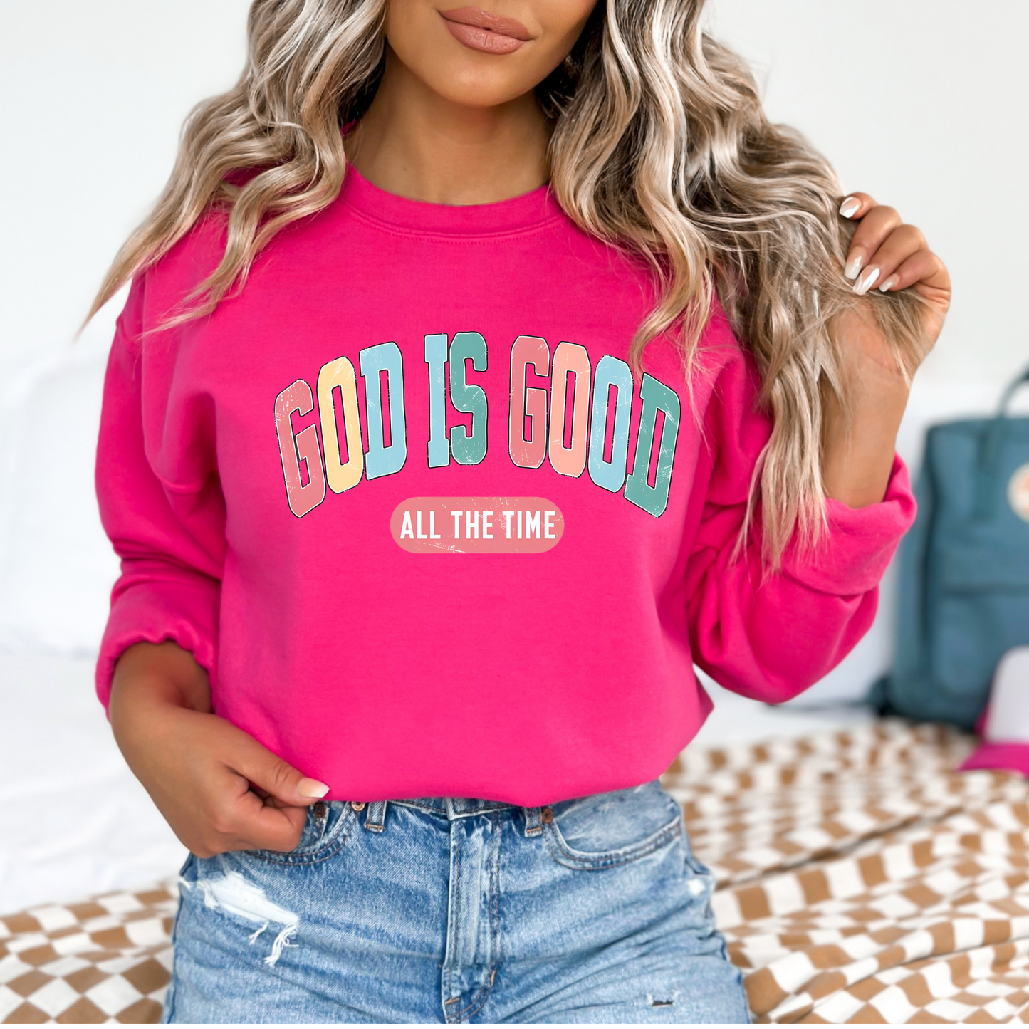 Woman wearing a dark pink 'God Is Good' Christian sweatshirt, faith-based crewneck with inspirational design.