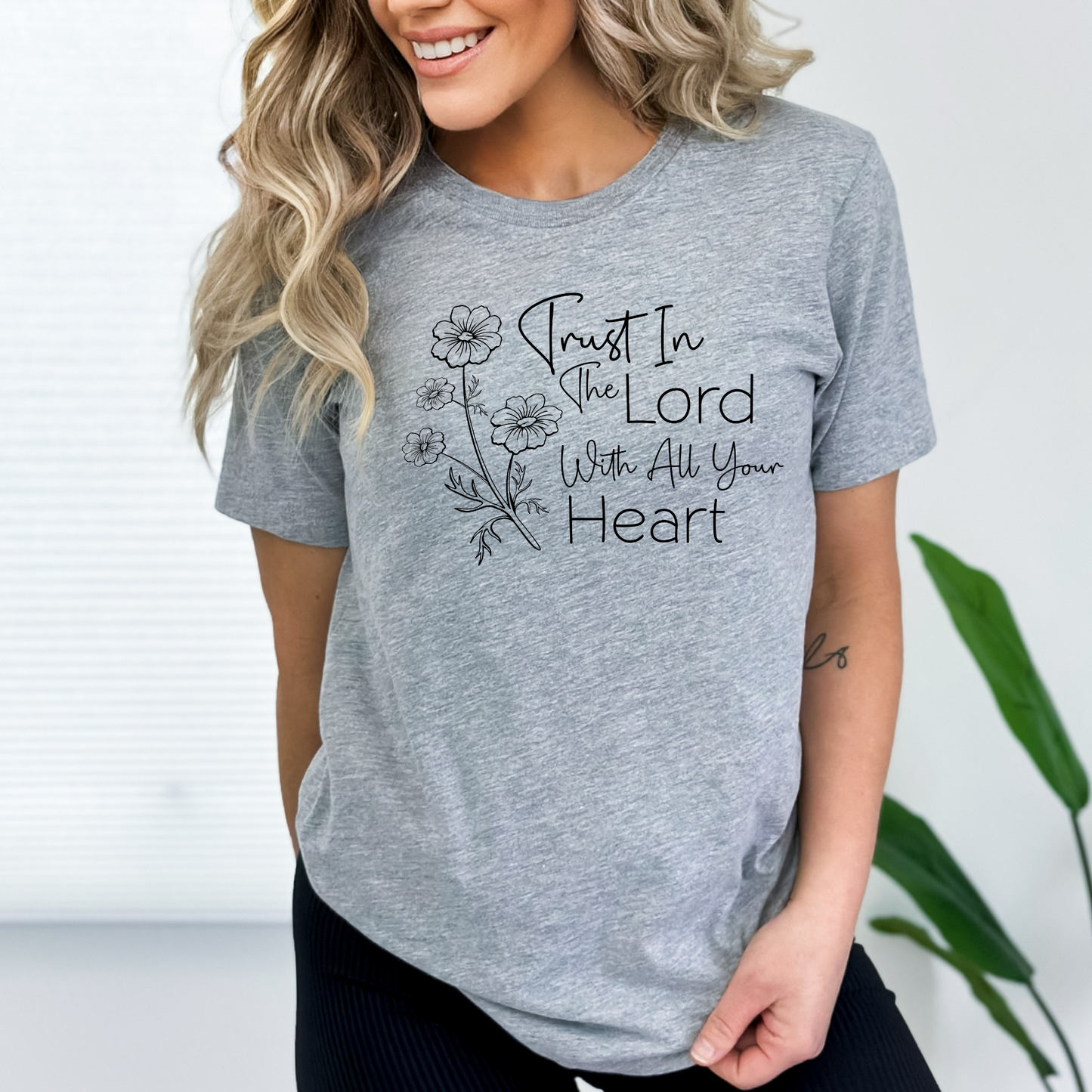 Inspirational Christian graphic tee for women with a floral scripture design. Trust in the Lord with all your heart message on a soft, stylish T-shirt.