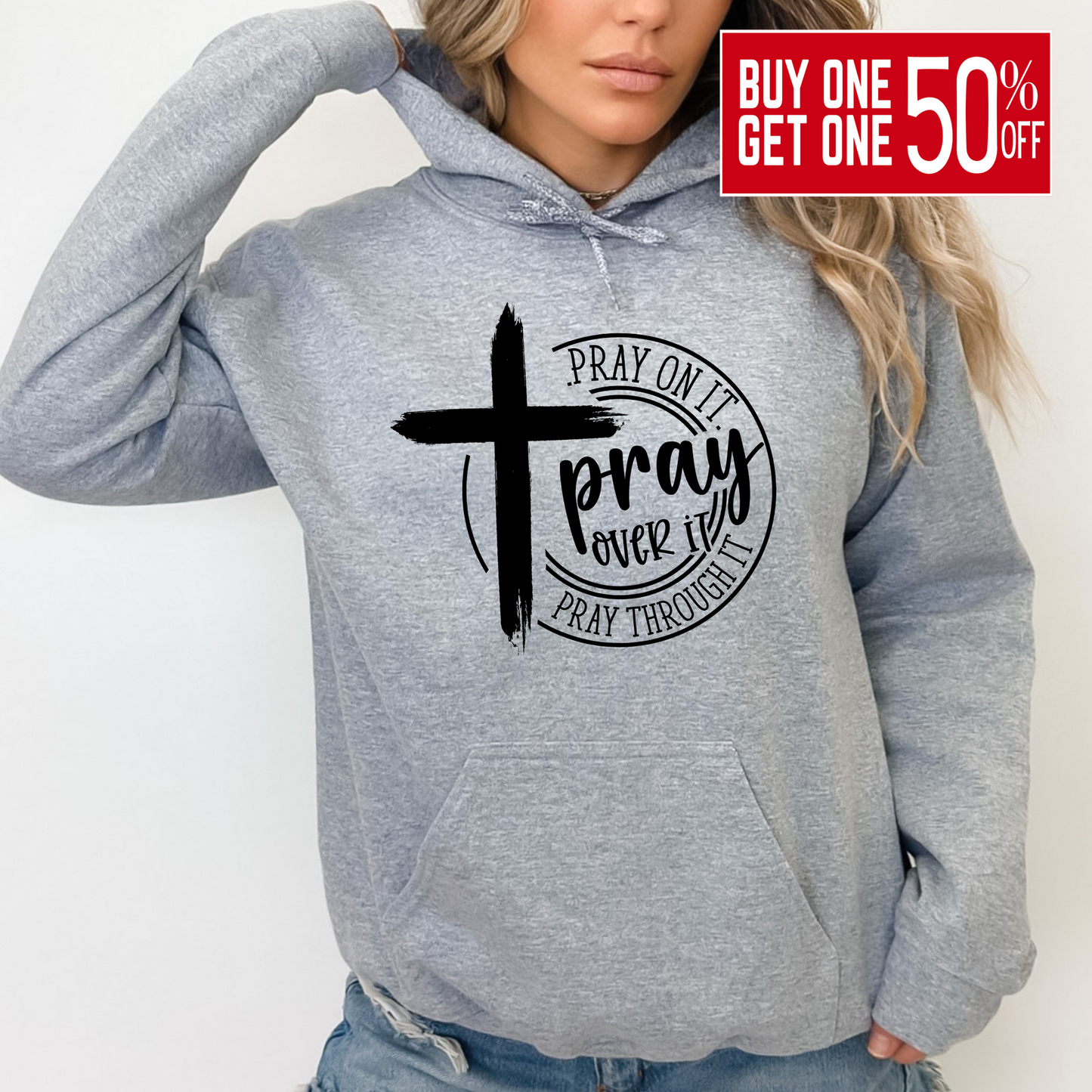 Woman wearing a Gray Christian hoodie with a motivational prayer message and cross symbol.