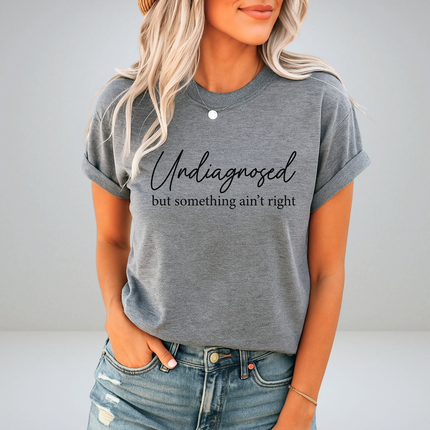 Gray rolled-sleeve tee with black print and casual outfit styling