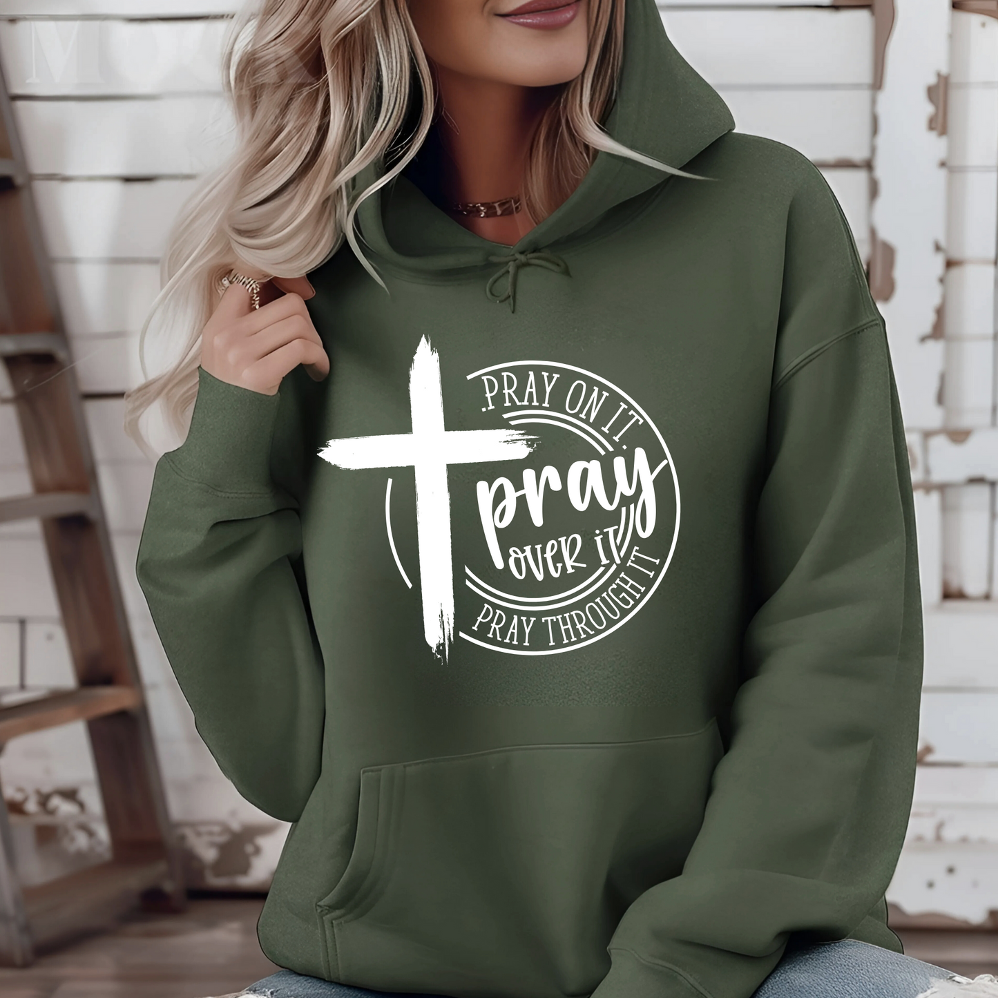 Woman wearing a Green Christian hoodie with a motivational prayer message and cross symbol.