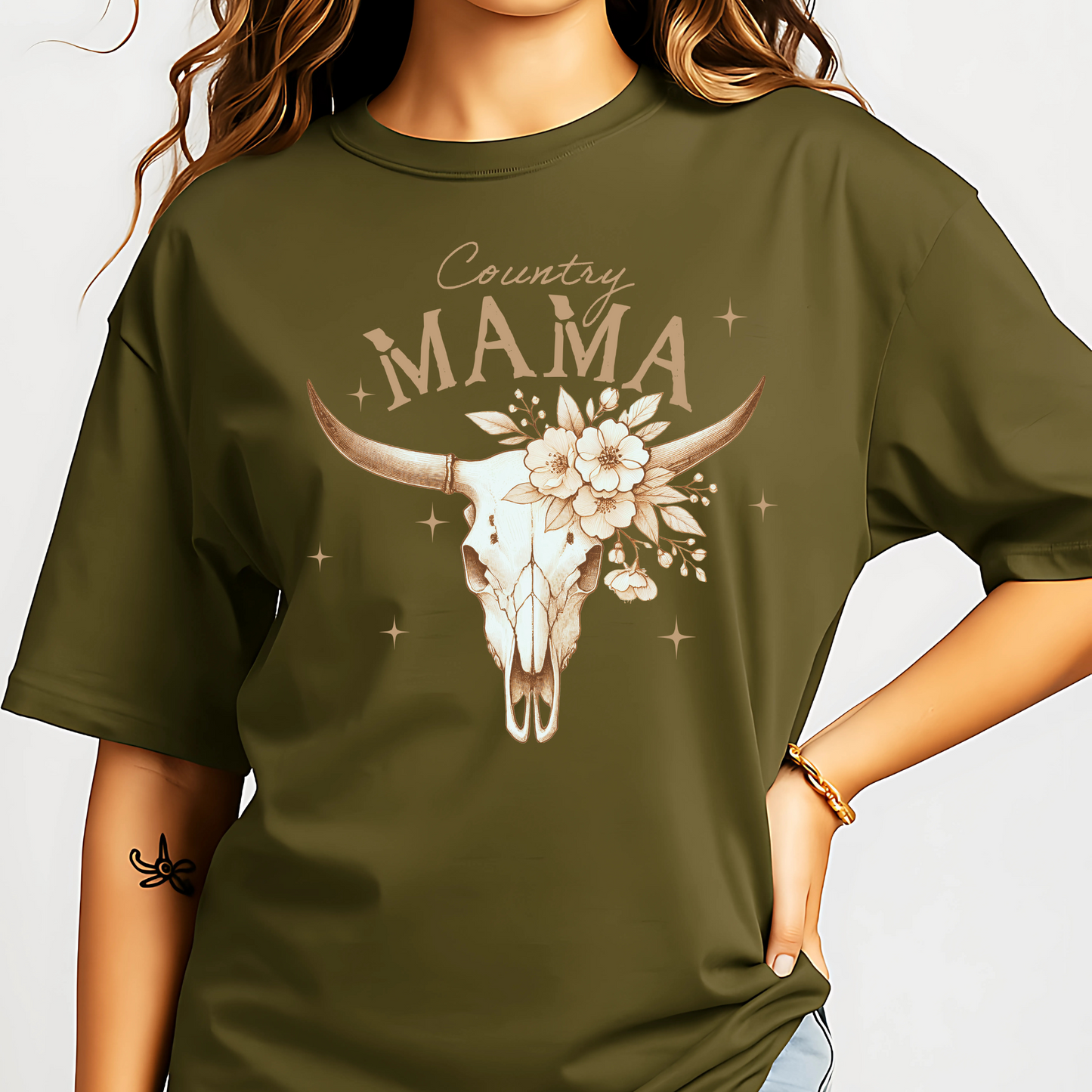 Woman wearing a Military Green, Rustic "Country Mama" Tee. Featuring floral cow skiull.