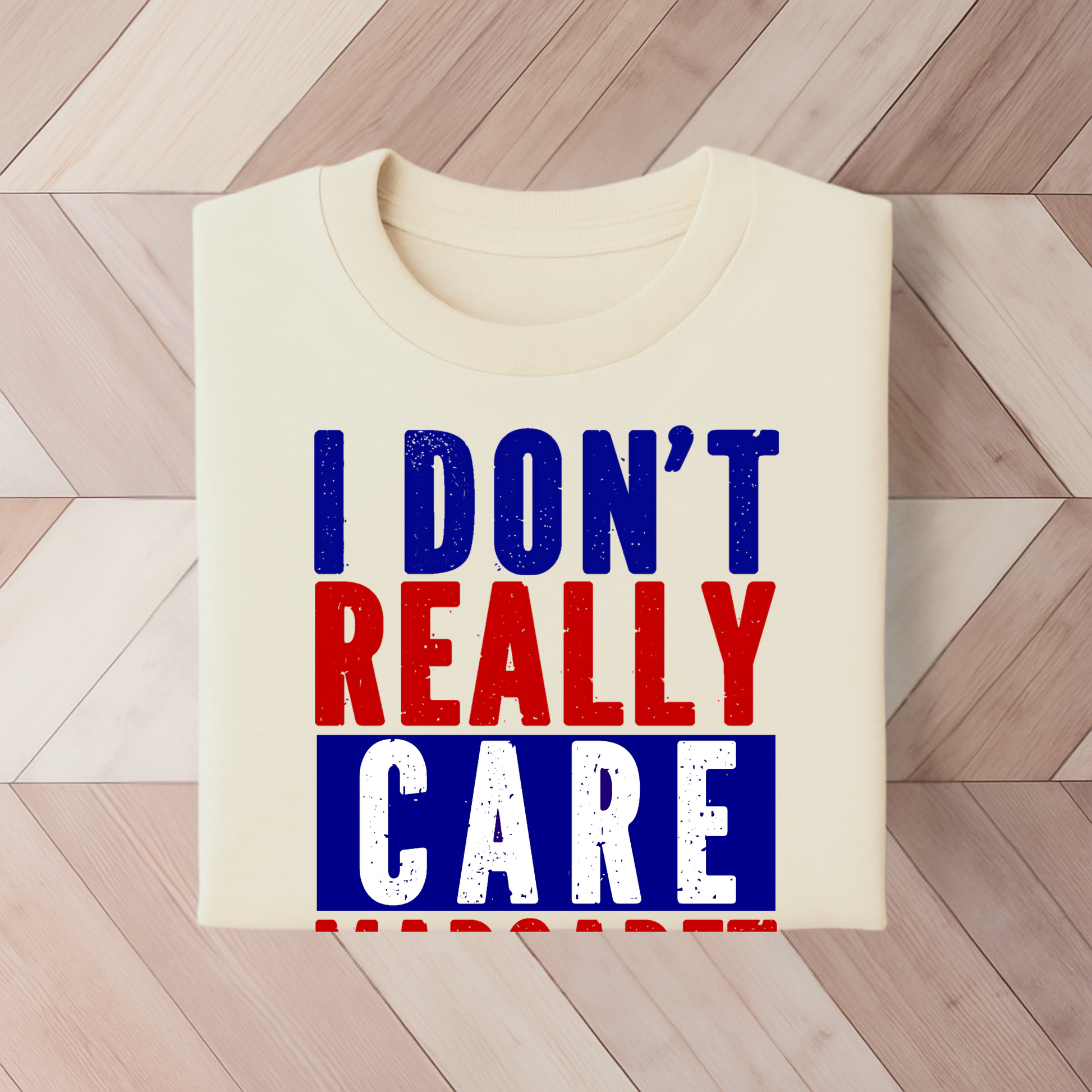 Sand colored  t-shirt with bold red, white, and blue text reading "I Don’t Really Care Margaret"