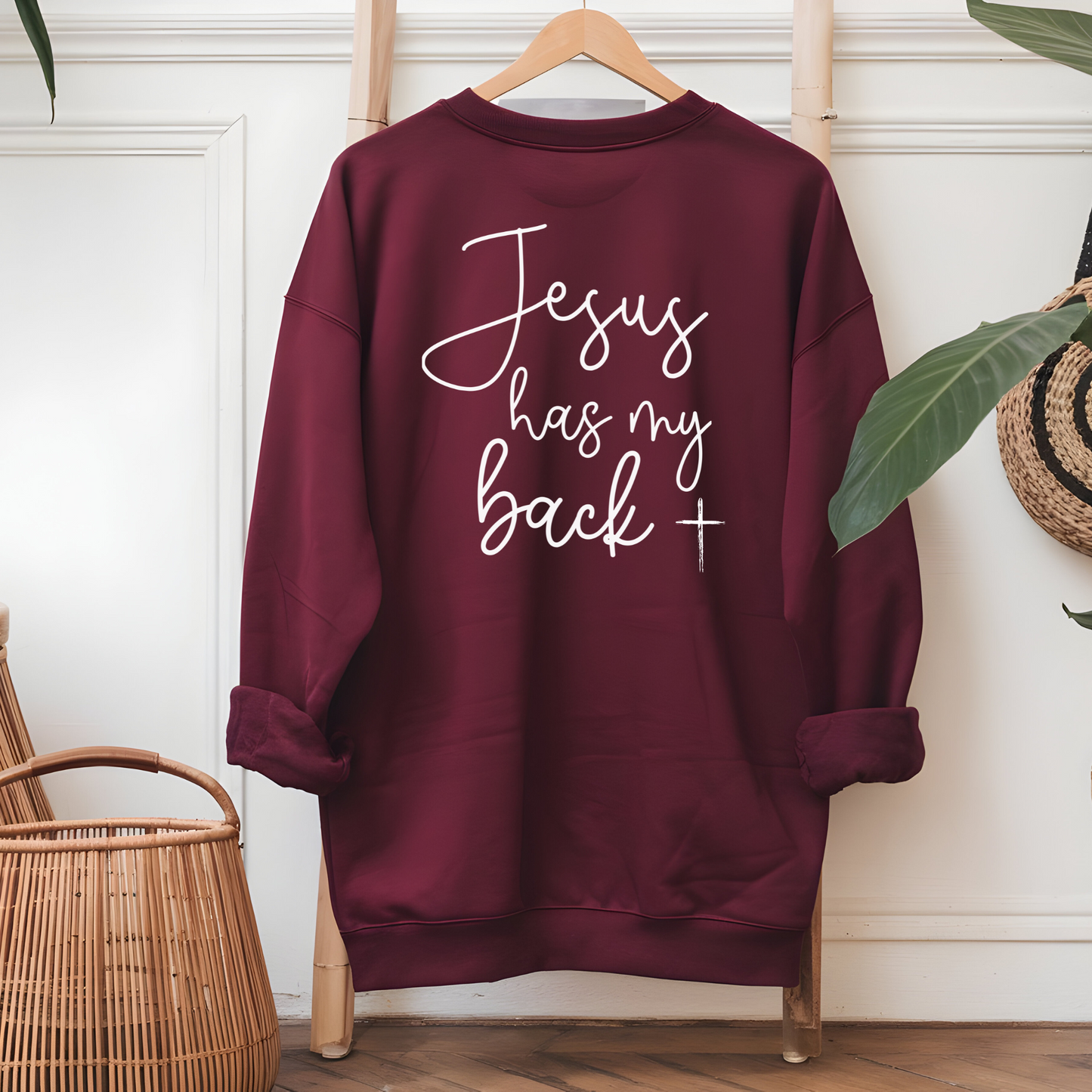 Maroon "Jesus has my back", back view of hanging sweatshirt