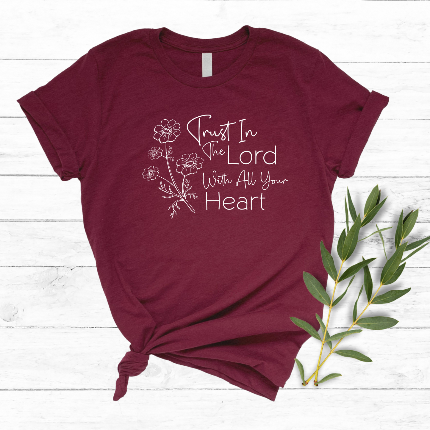 Christian graphic tee featuring ‘Trust in the Lord’ scripture with a delicate floral print. Comfortable, stylish, and faith-inspired apparel for women