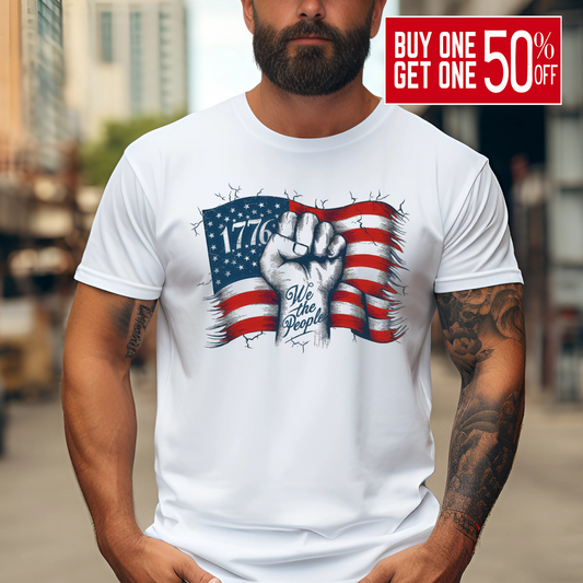 Man in sand 1776 shirt with American flag design and tattooed arm