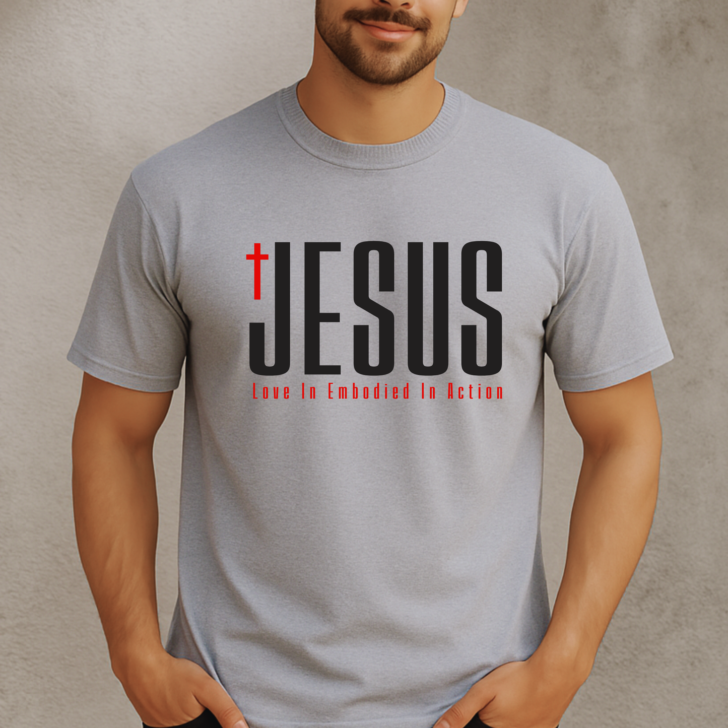 Men’s sport gray Christian JESUS T-shirt featuring cross and “Love In Embodied In Action” message – unisex religious shirt in sizes S–3X, tall sizes available.