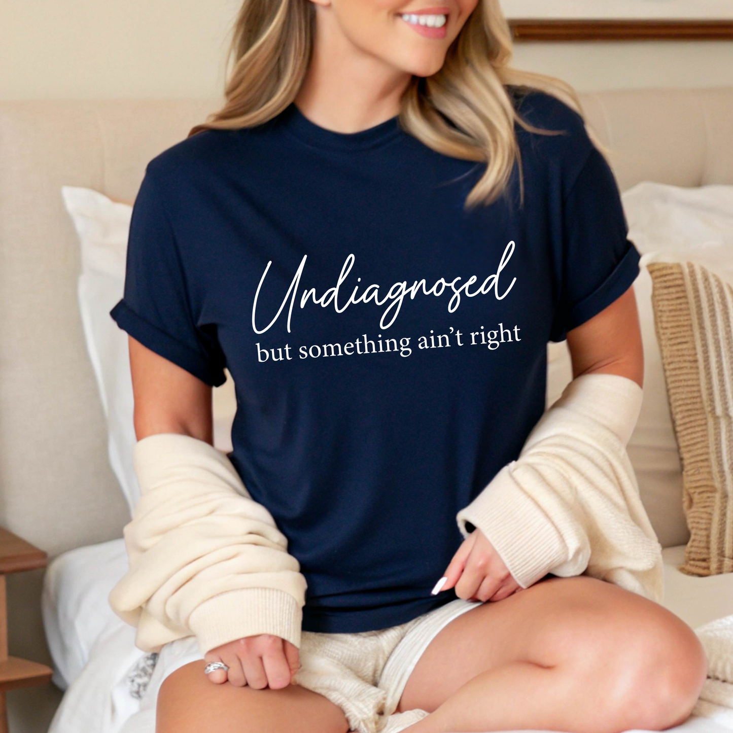Navy shirt styled with jeans, script quote in white text