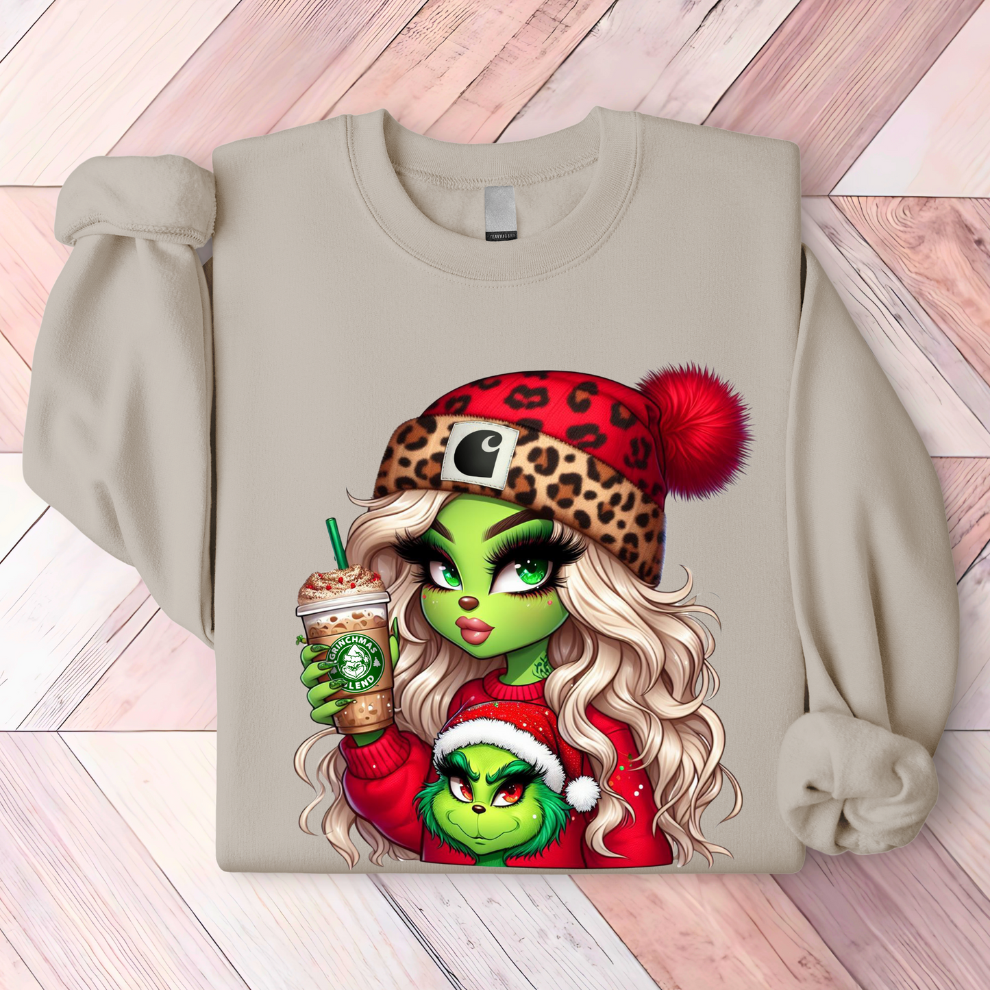 Sand-colored Christmas shirt showcasing a chic green holiday girl and a small green character in Santa gear with a holiday coffee.
