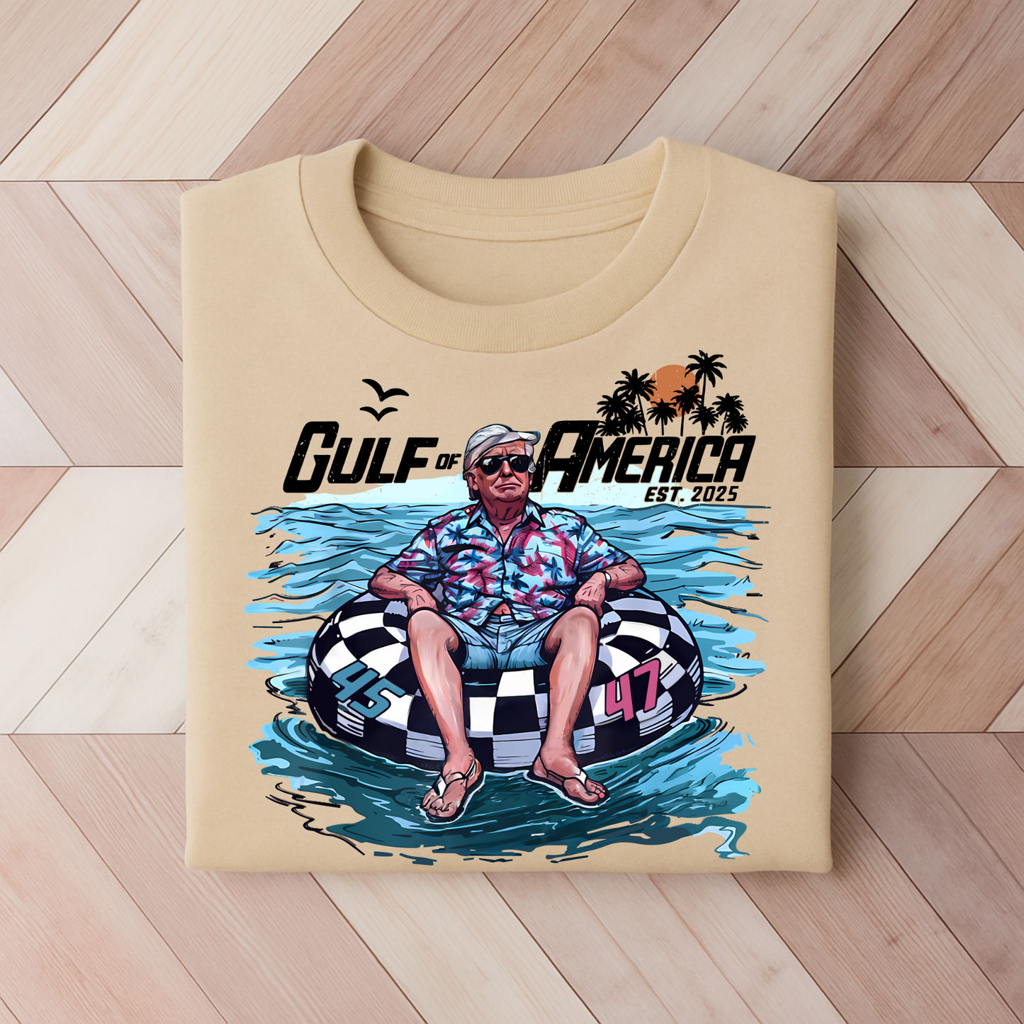 Sand Gulf of America Trump 2025 shirt with cartoon beach design and patriotic theme.
