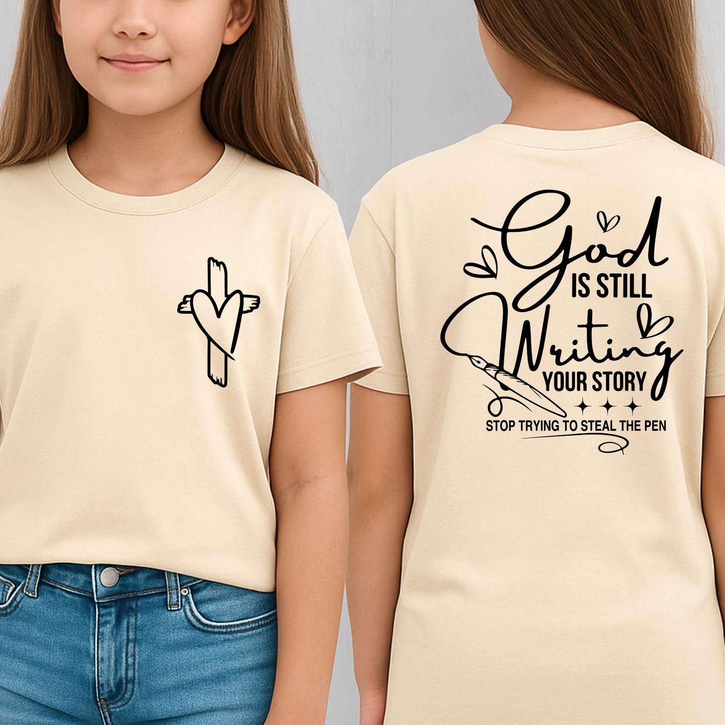Sand colored Christian youth tee with “God is still writing your story” back design