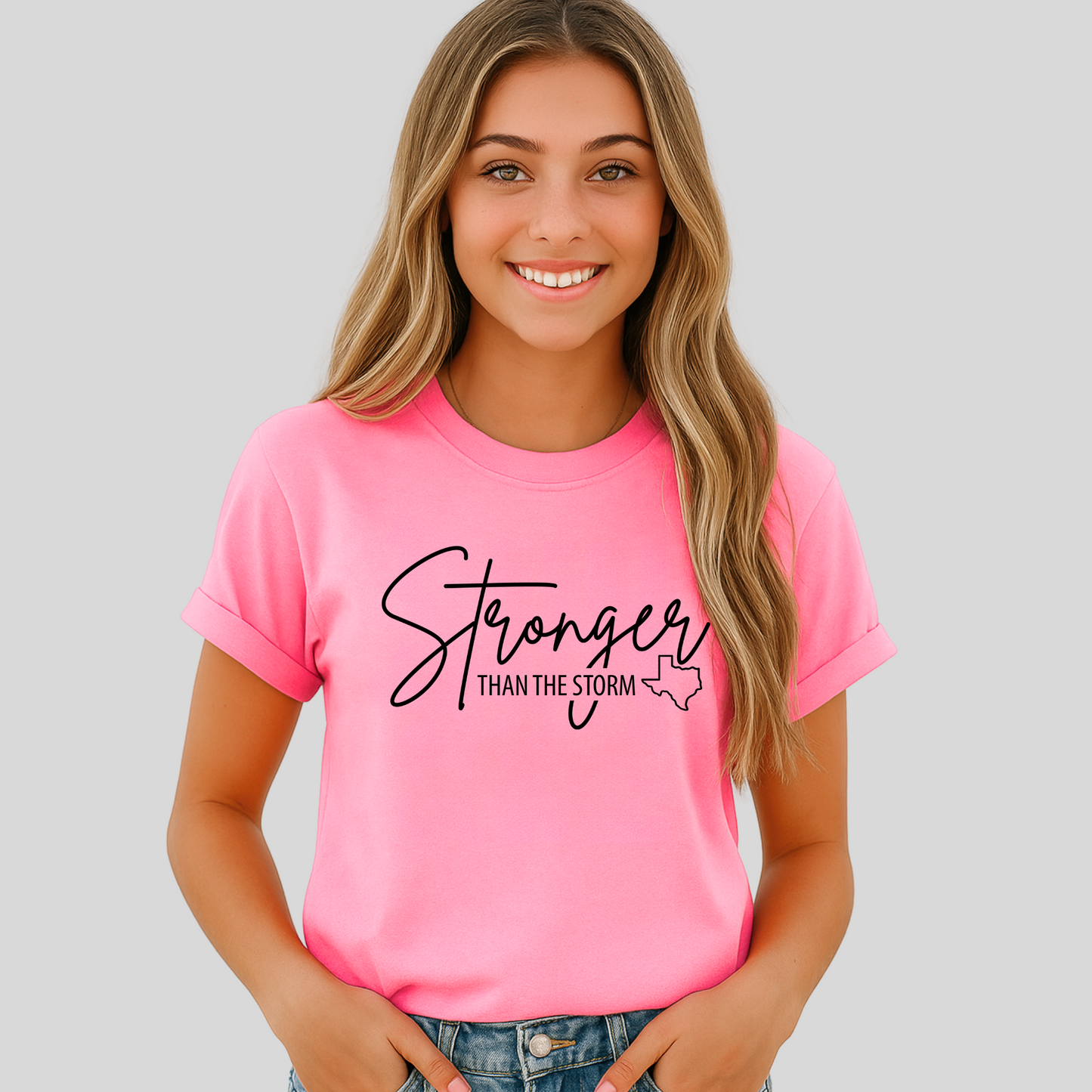 Teen girl in hot pink Texas support tee with “Stronger Than the Storm” message, faith-based teen shirt.