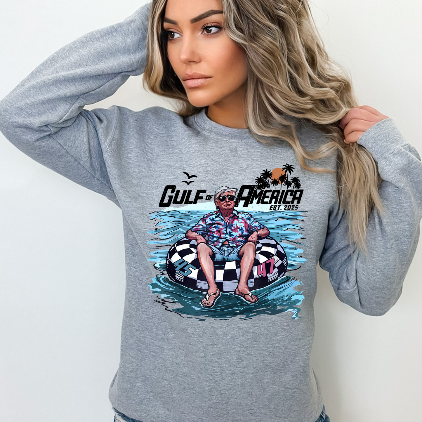 woman wearing gray Gulf of America sweatshirt – Trump vacation parody design