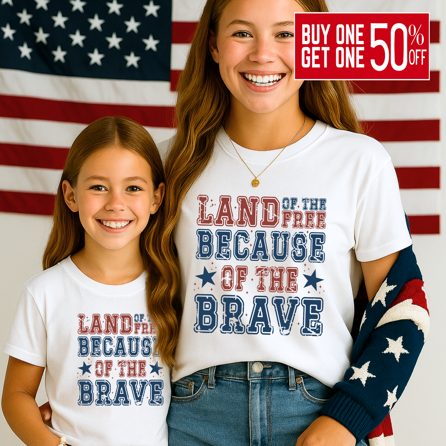 Young girls wearing white "Land of the Free Because of the Brave" t-shirt with American Flag in the background