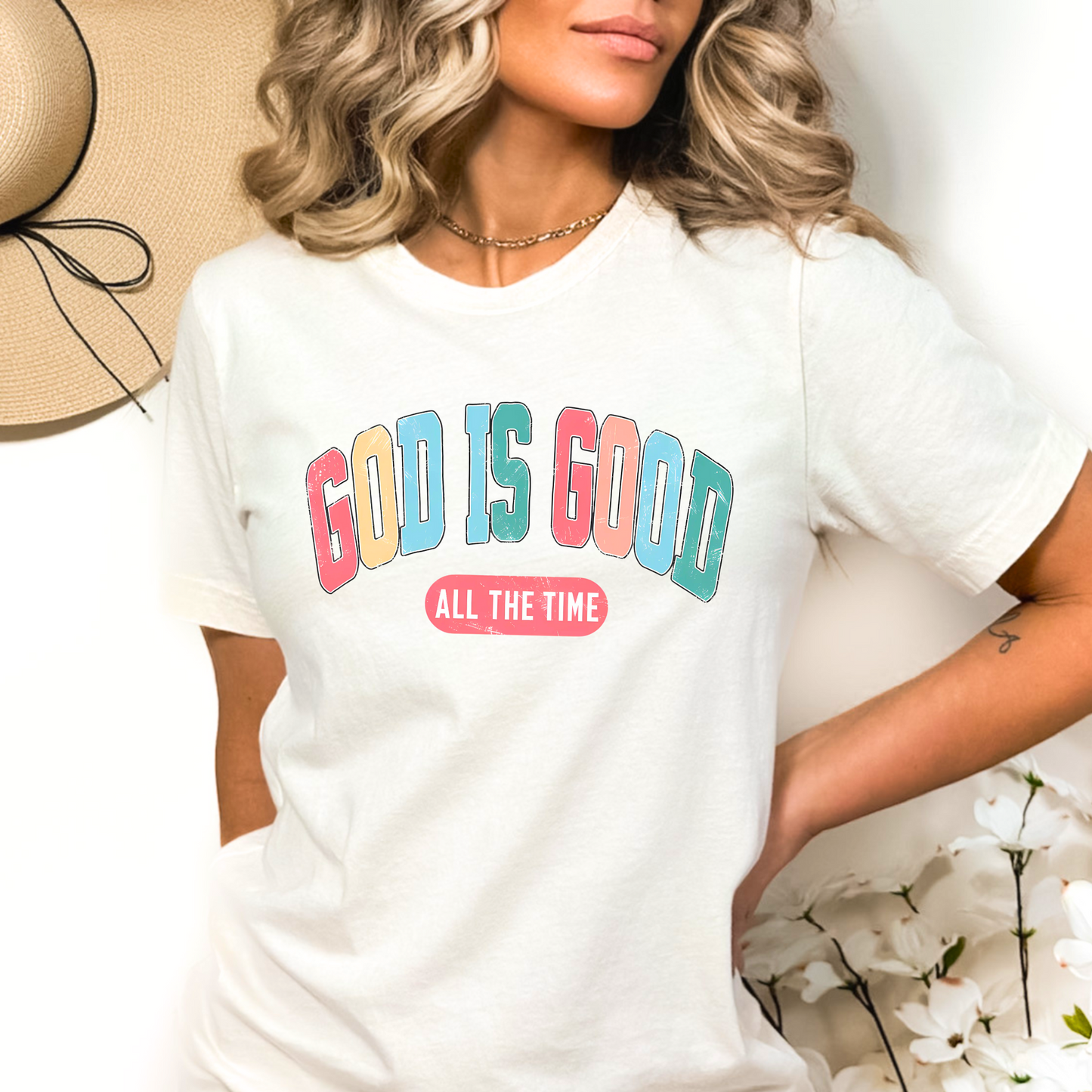 Woman wearing a white ‘God Is Good All The Time’ Christian t-shirt, faith-based graphic tee.
