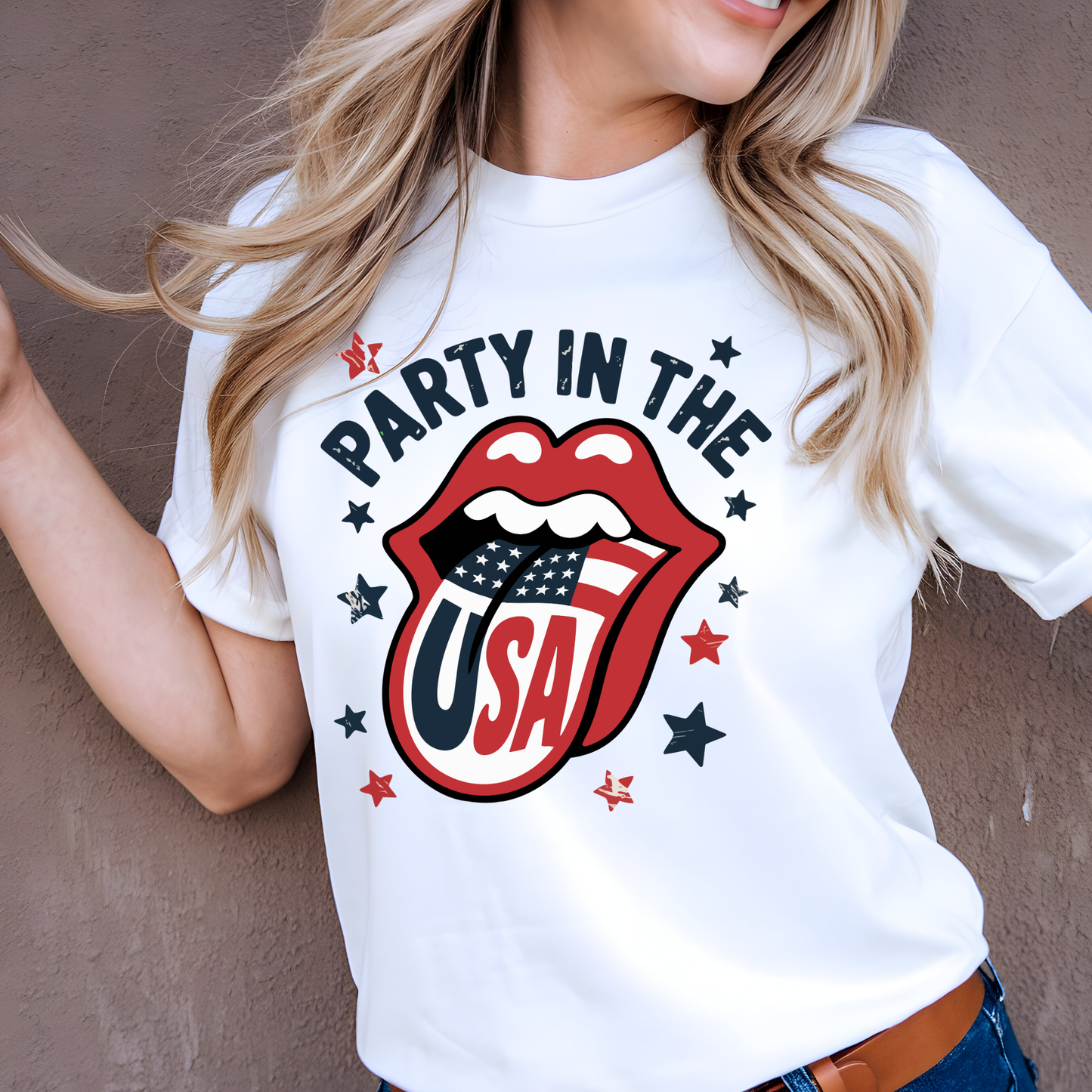 Happy woman wearing white “Party in the USA” shirt with bold graphic design. Patriotic lips with flag tongue surrounded by stars. Great for summer, 4th of July parties, and patriotic fashion.