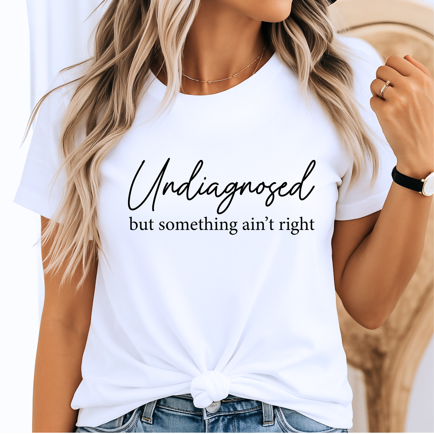 White shirt styled with jeans, script quote in black text