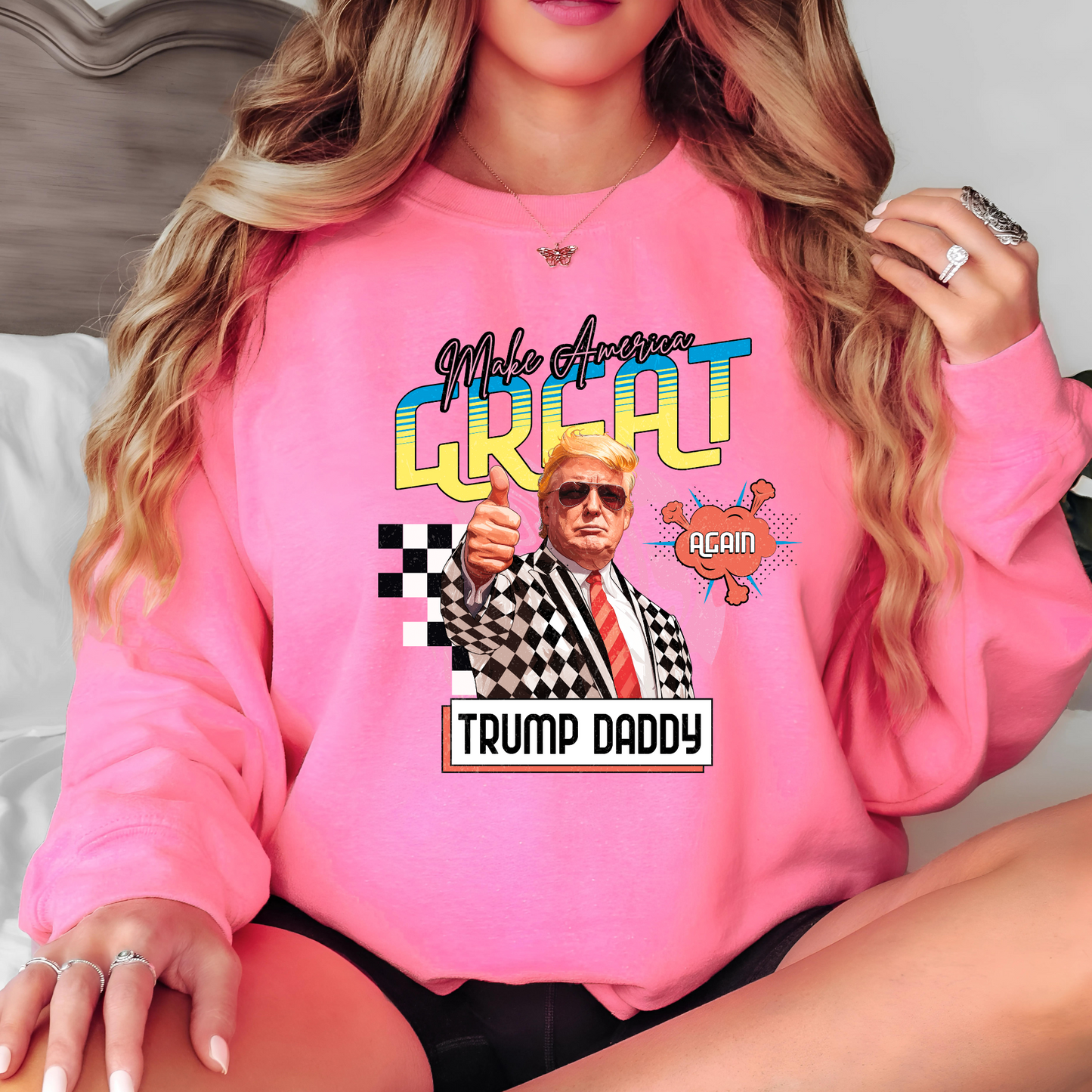 Woman in pink Trump Daddy sweatshirt with long blonde hair