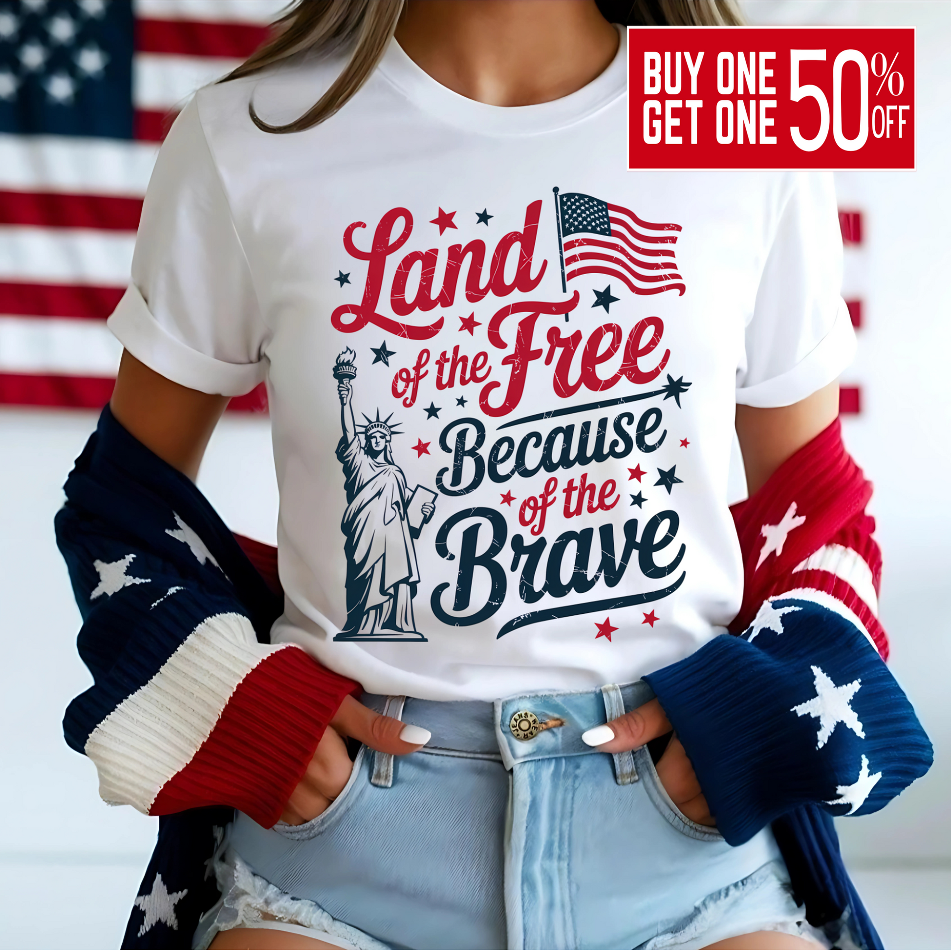 Woman in white tee with red/blue patriotic print, smiling in front of flag