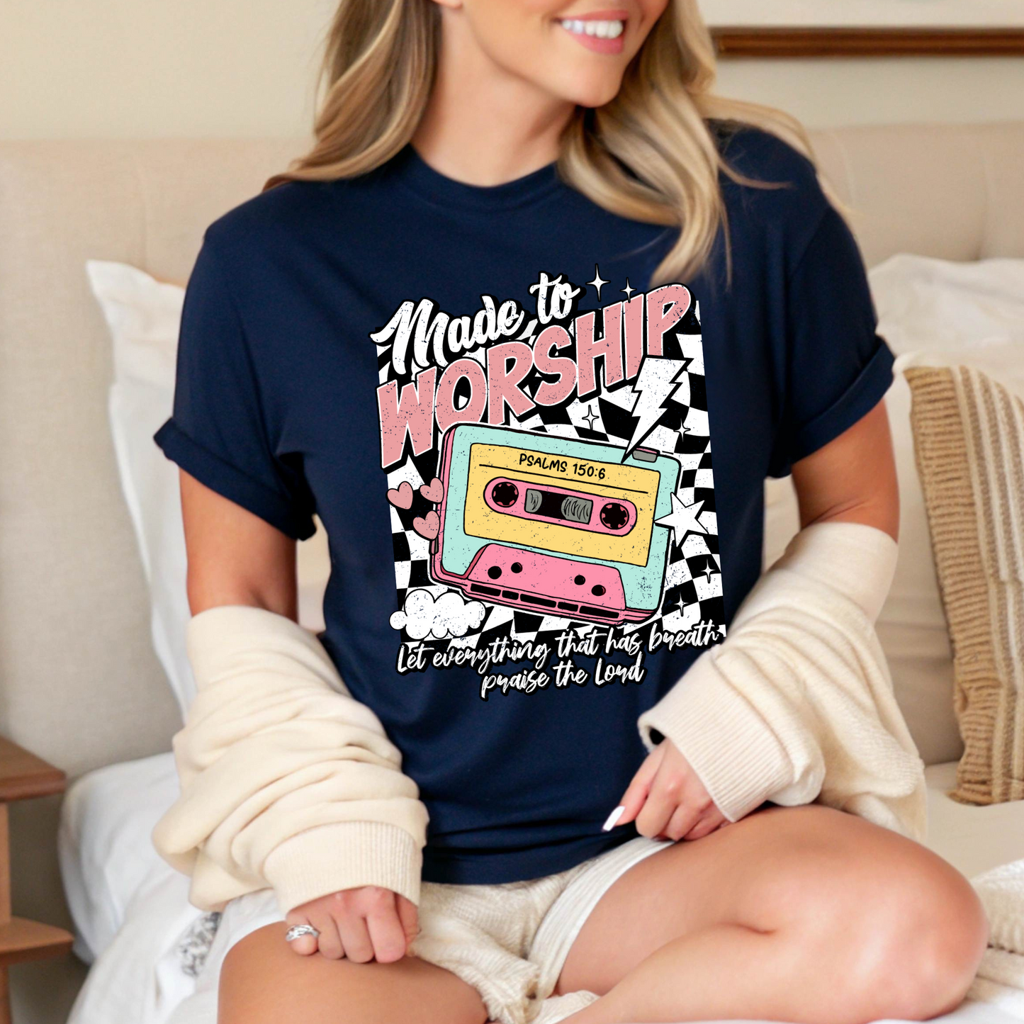 Woman sitting indoors wearing navy blue Christian cassette tee