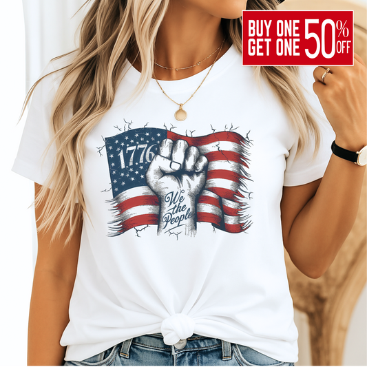 Woman wearing white 1776 We The People shirt with blue jeans, smiling – front view.
