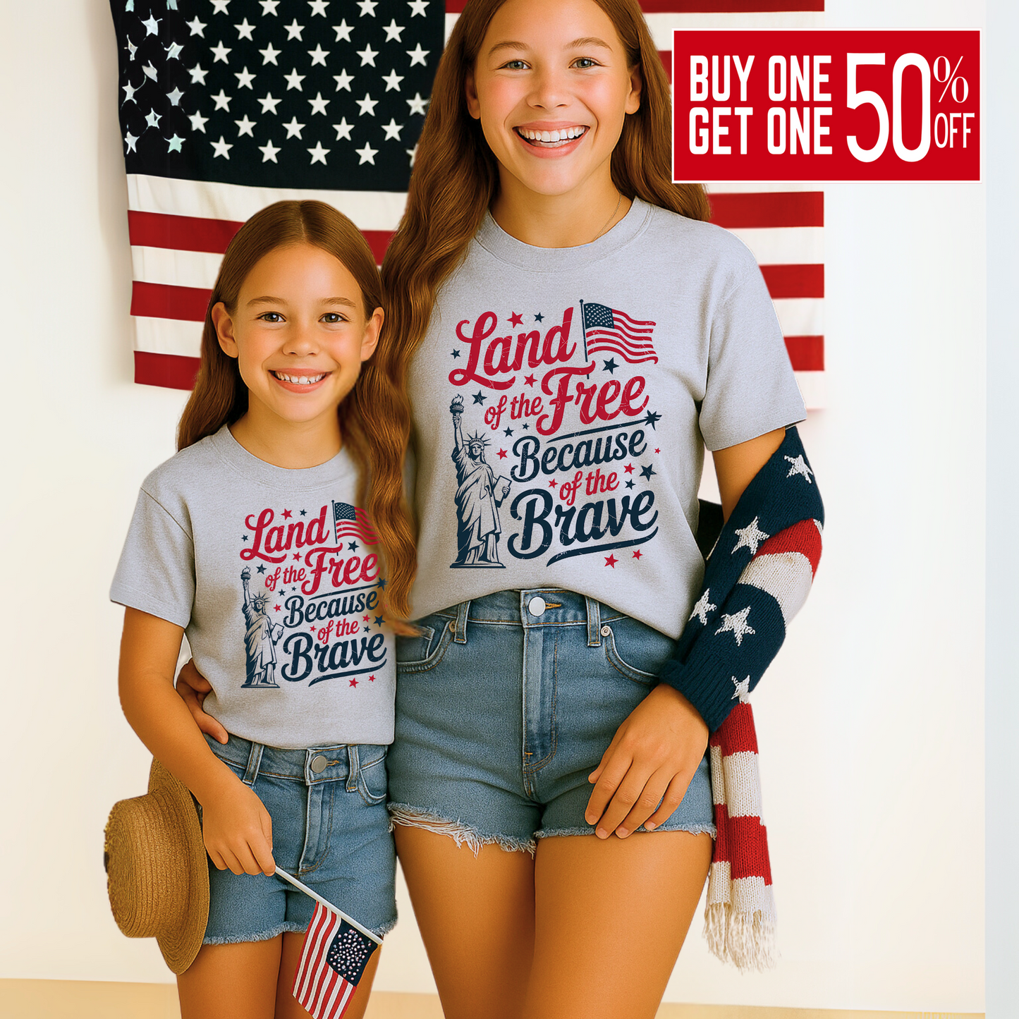 Young girl in gray 4th of July tee holding an American flag and smiling