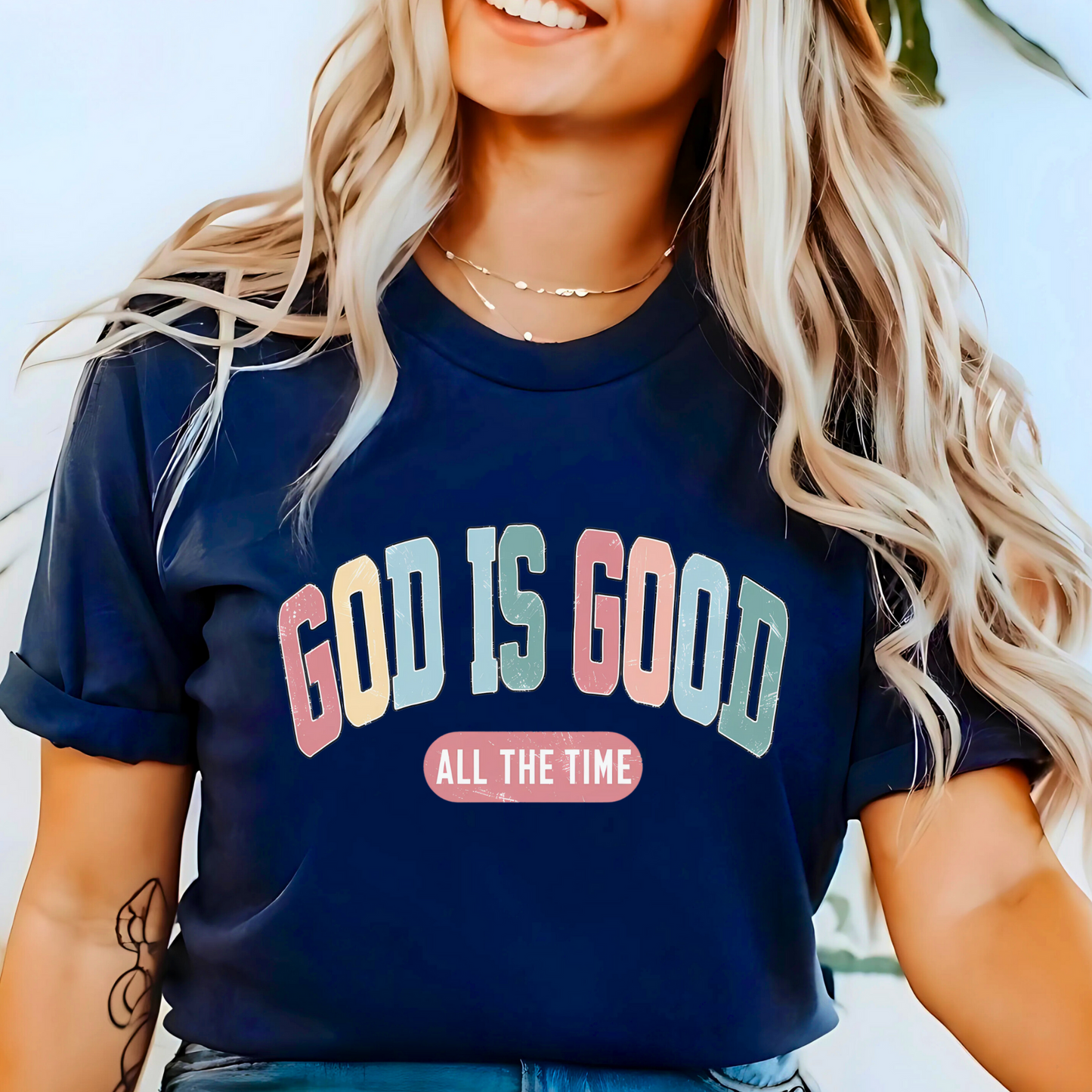 Woman wearing a Navy God Is Good All The Time’ Christian t-shirt, faith-based graphic tee.