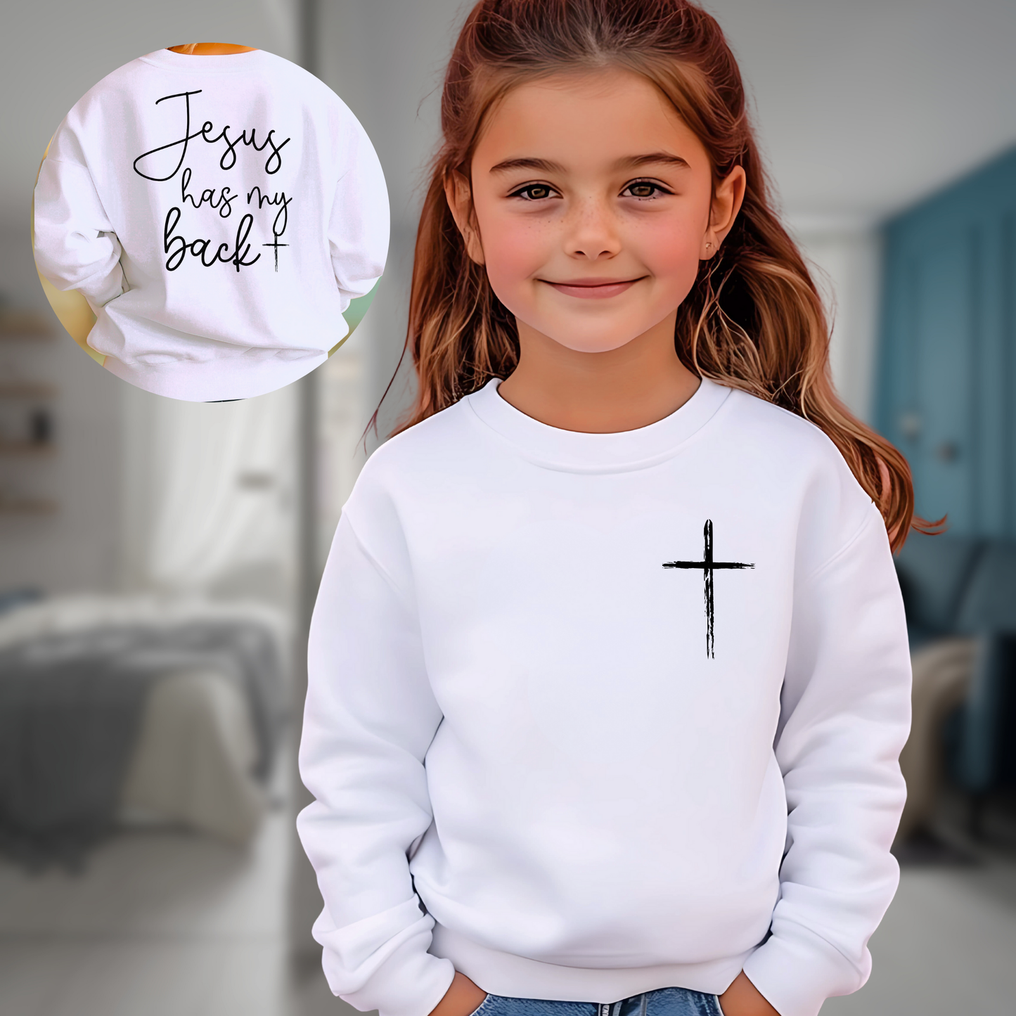 Young girl wearing a white 'Jesus Has My Back' youth sweatshirt with a cross design, faith-based Christian apparel for kids