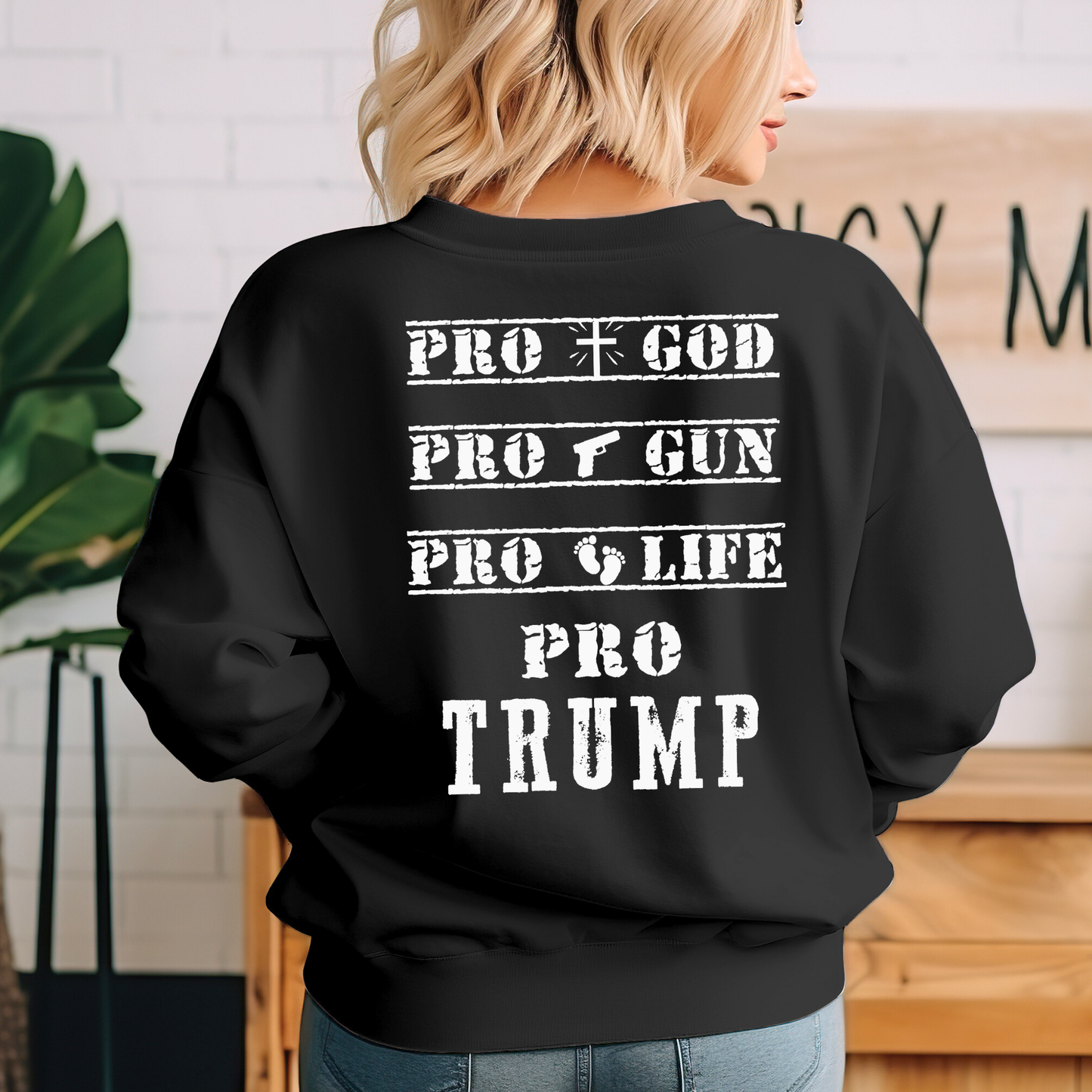 Black sweatshirt with White American flag on the front and bold Pro God, Pro Gun, Pro Life, Pro Trump text on the back. Patriotic Christian conservative apparel