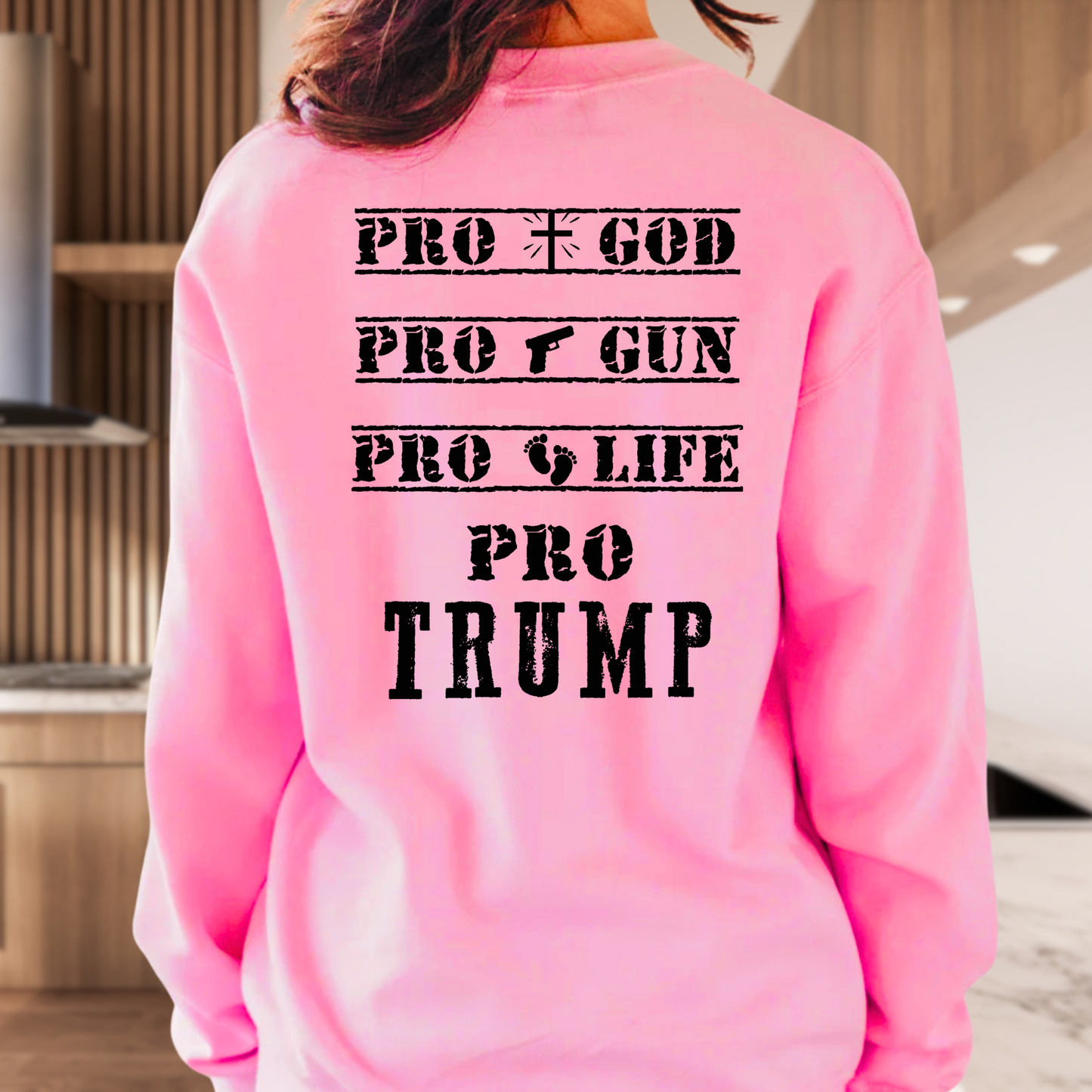 Bright Pink sweatshirt with Black American flag on the front and bold Pro God, Pro Gun, Pro Life, Pro Trump text on the back. Patriotic Christian conservative apparel