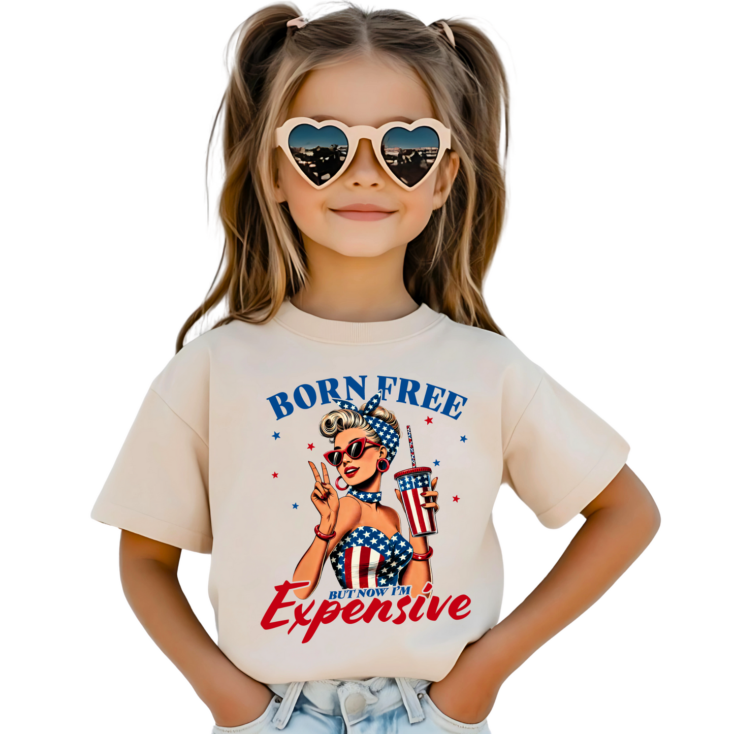 Sand color patriotic T-shirt with retro sunglasses woman in flag outfit saying Born Free But Now I'm Expensive
