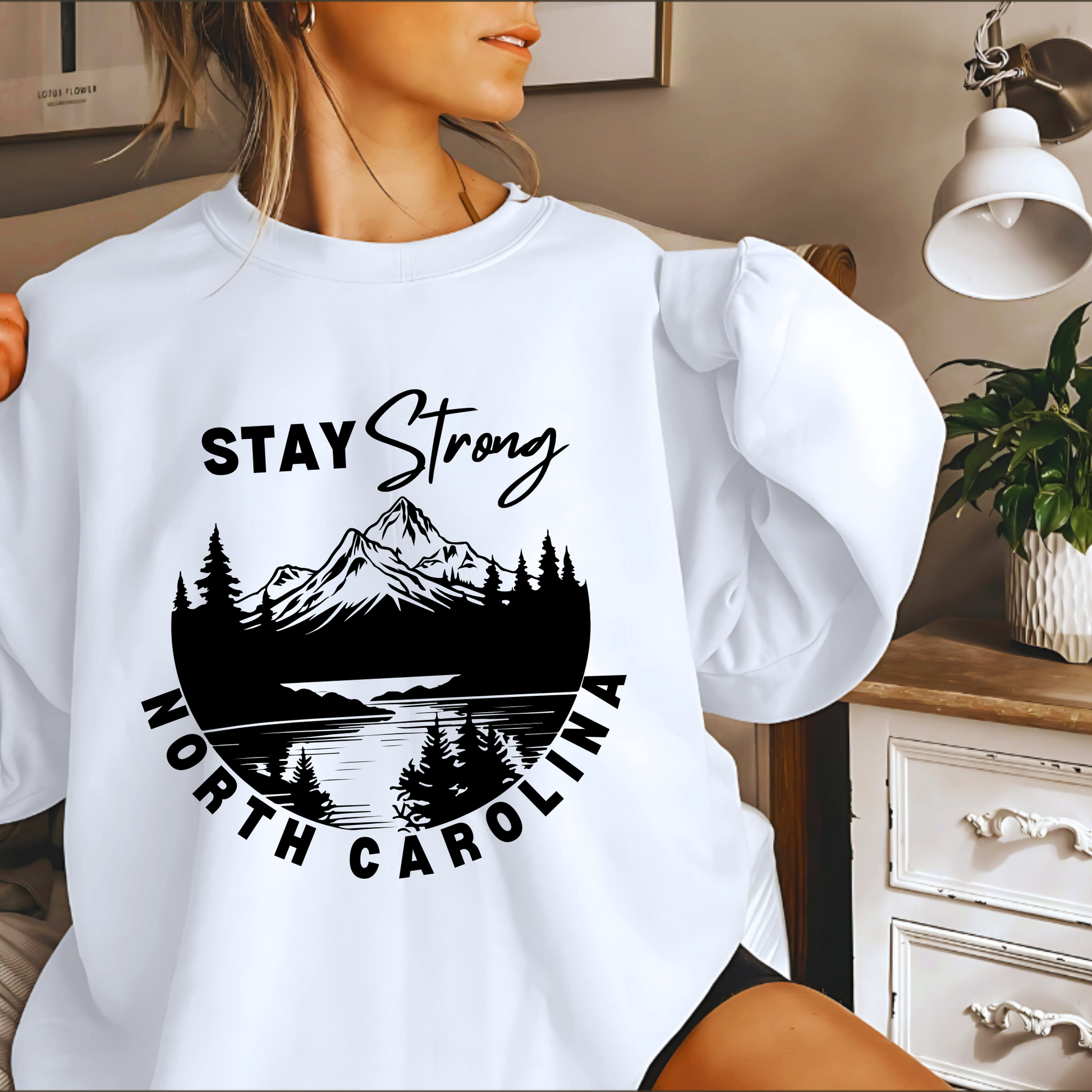 affected by Hurricane Helene in Western North Carolina with this custom "North Carolina Stay Strong" design. The majority of proceeds from these sales will be donated directly to families affected. 