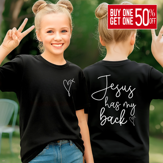 Two children wearing black t-shirts with 'Jesus has my back' text outdoors.
