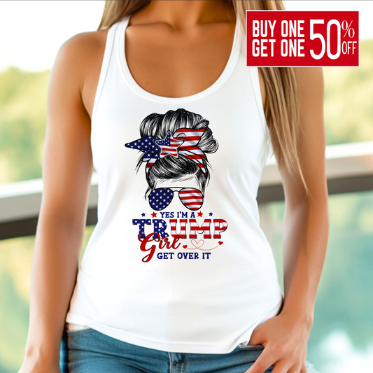 A woman wearing a white tank top with a graphic design that includes the American flag and text