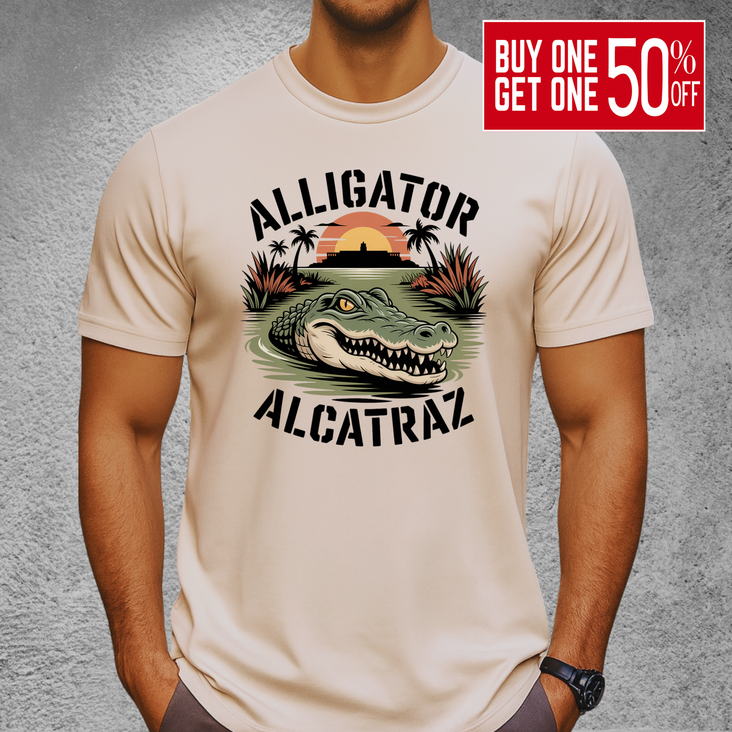 Athletic man wearing a sand-colored Alligator Alcatraz T-shirt. Graphic includes an aggressive alligator in marsh water with a distant sunset over Alcatraz. Perfect rugged men’s shirt for outdoor lovers and vacation style.

