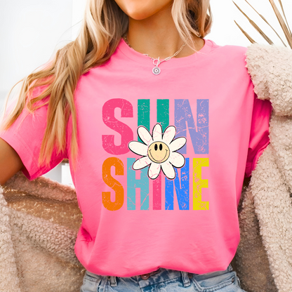 Bright pink tee with bold graphic, styled with fuzzy jacket